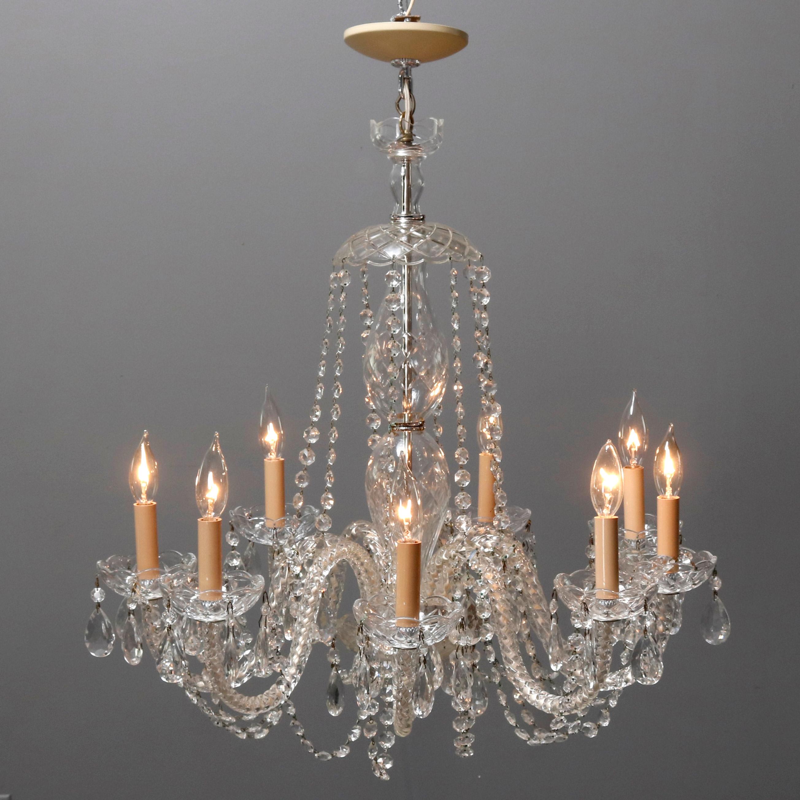 A vintage oversized Continental French chandelier offers chrome frame with nine s-scroll crystal arms terminating in candle lights and cut and strung crystals throughout, circa 1910.


Measures - 29.75