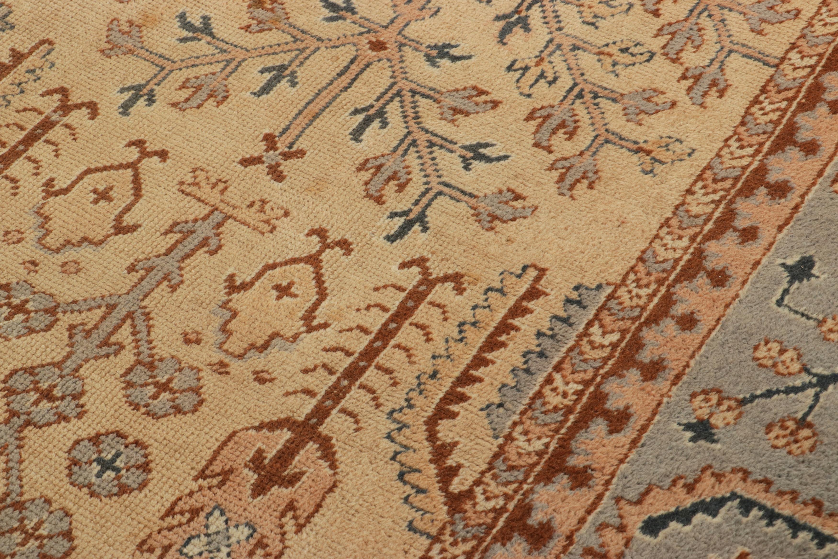 Hand-knotted in wool originating from Turkey circa 1950-1960, this 12x18 oversized vintage rug connotes a mid-century Oushak rug design of rich, unexpected color and exceptional detail, enjoying a medallion pattern in 3x6 size and further good