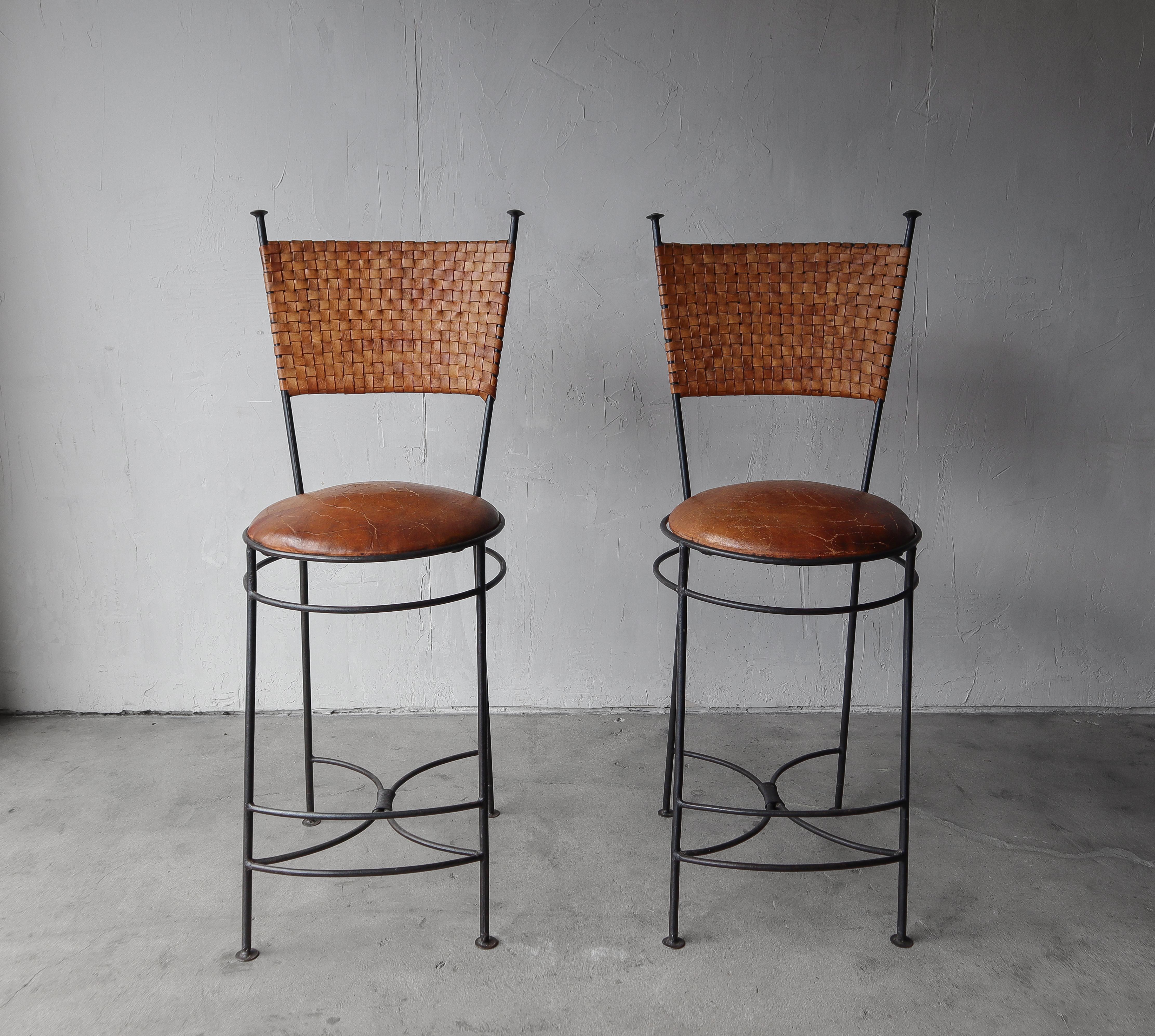 Pair of perfectly patinaed, woven leather, bar stools. Stools have beautifully worn leather for that great Industrial look.   They are oversized, perfect for someone who needs just 2.

The stools have beautiful wear and patina on the leather, marks