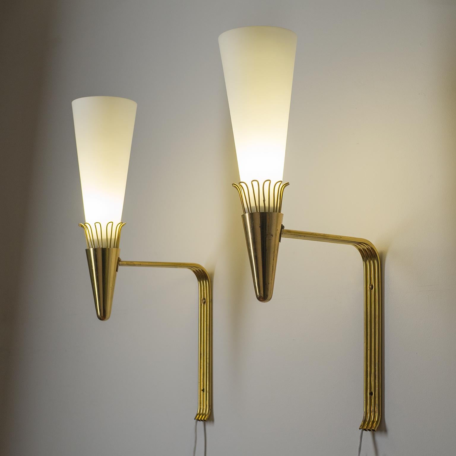 Rare pair of very large brass and satin glass wall lights by Itsu, Finland, circa 1960. Remarkable modernist design in good original condition with patina on the brass. One original bakelite E27 socket with new textile wiring. Manufacturers stamp on