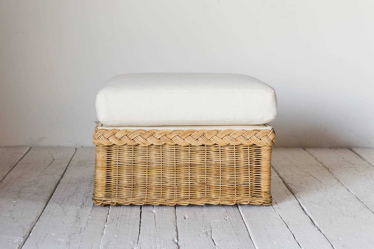 Oversized wicker ottoman upholstered in white hemp with loose cushion.