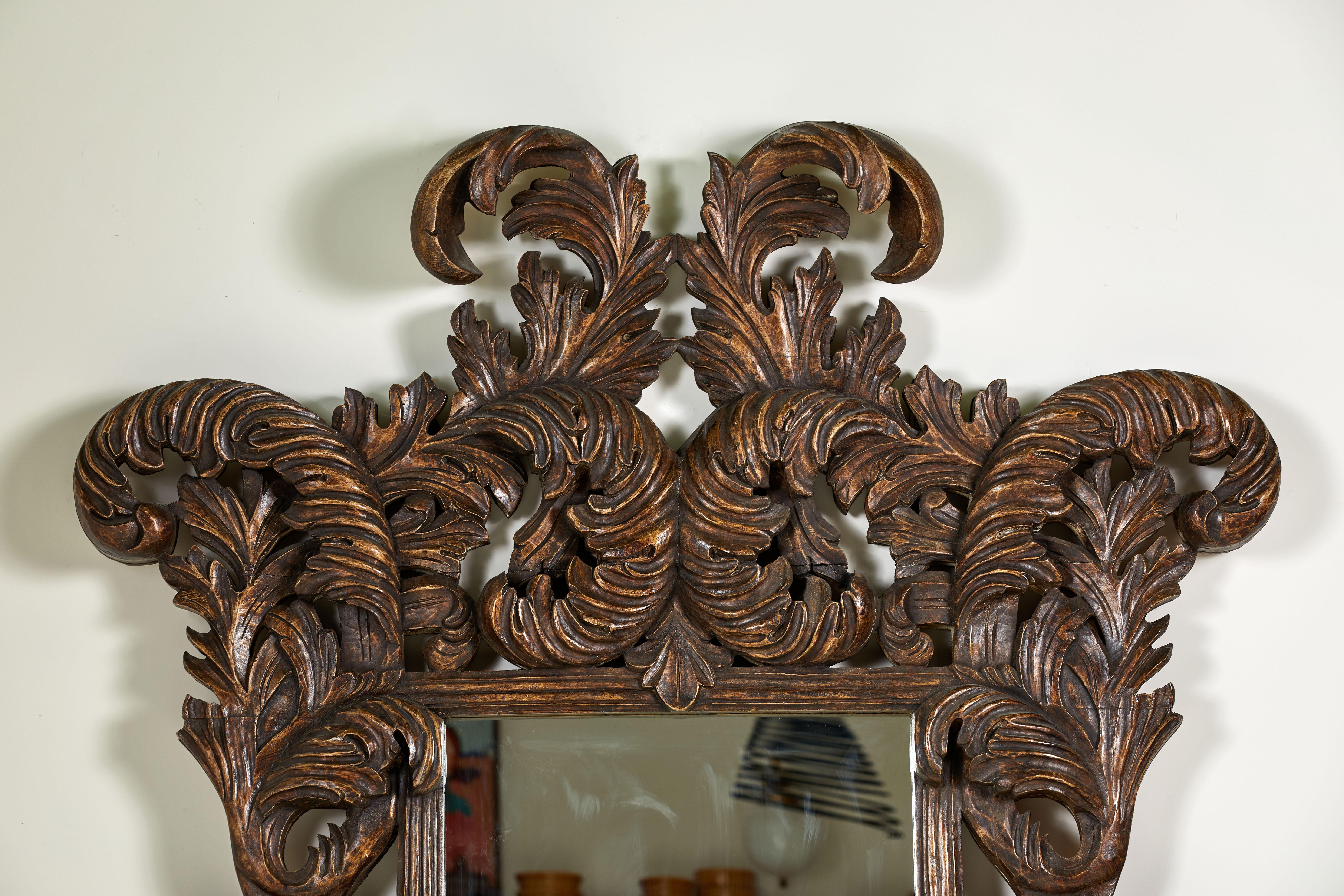 Oversized and large scaled beautifully and intricately carved wooden mirror.