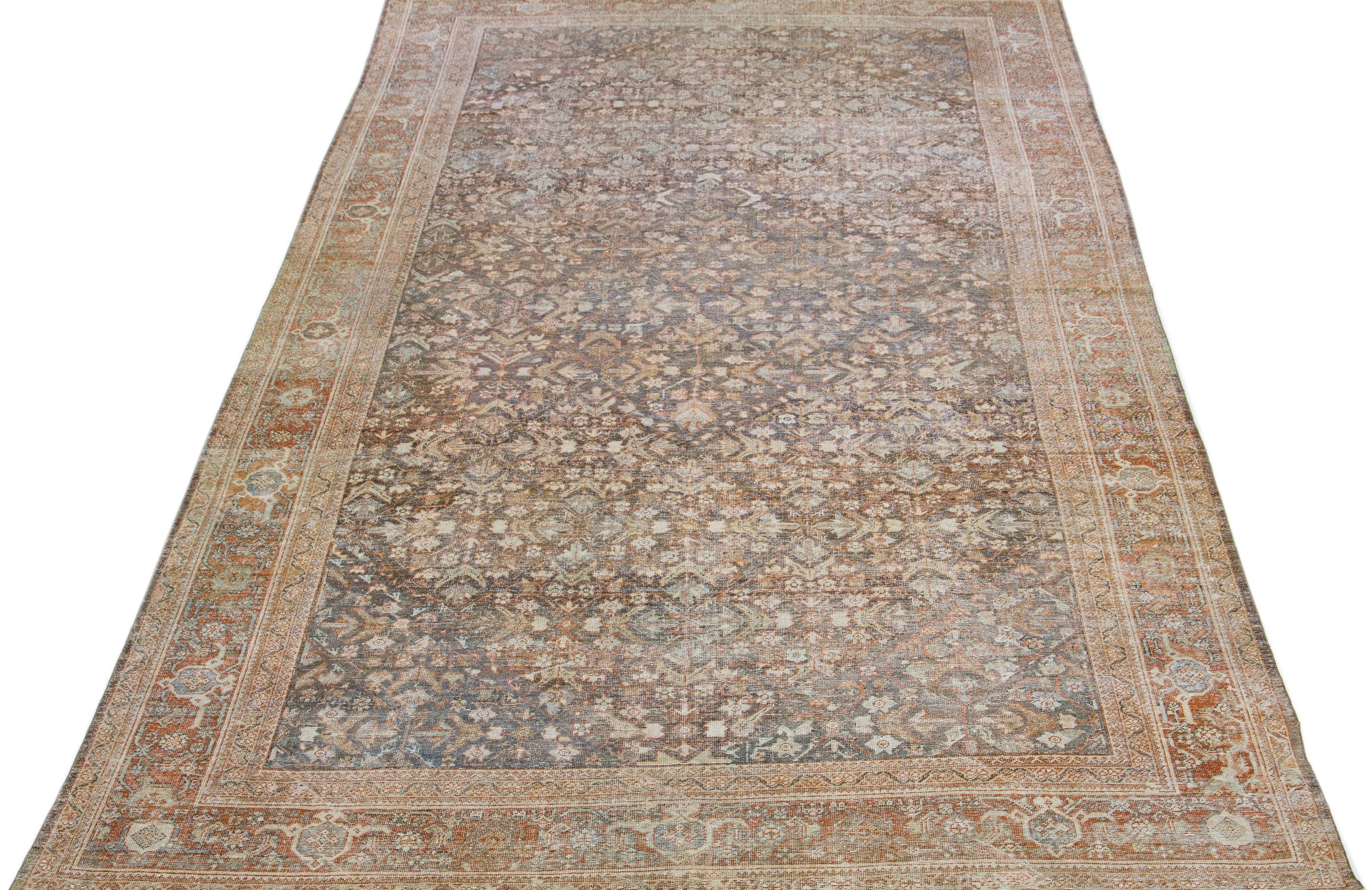 Beautiful antique Mahal hand-knotted wool rug with a gray color field. This Persian rug has orange-rust and brown accents in a gorgeous traditional floral motif.

This rug measures: 10'1