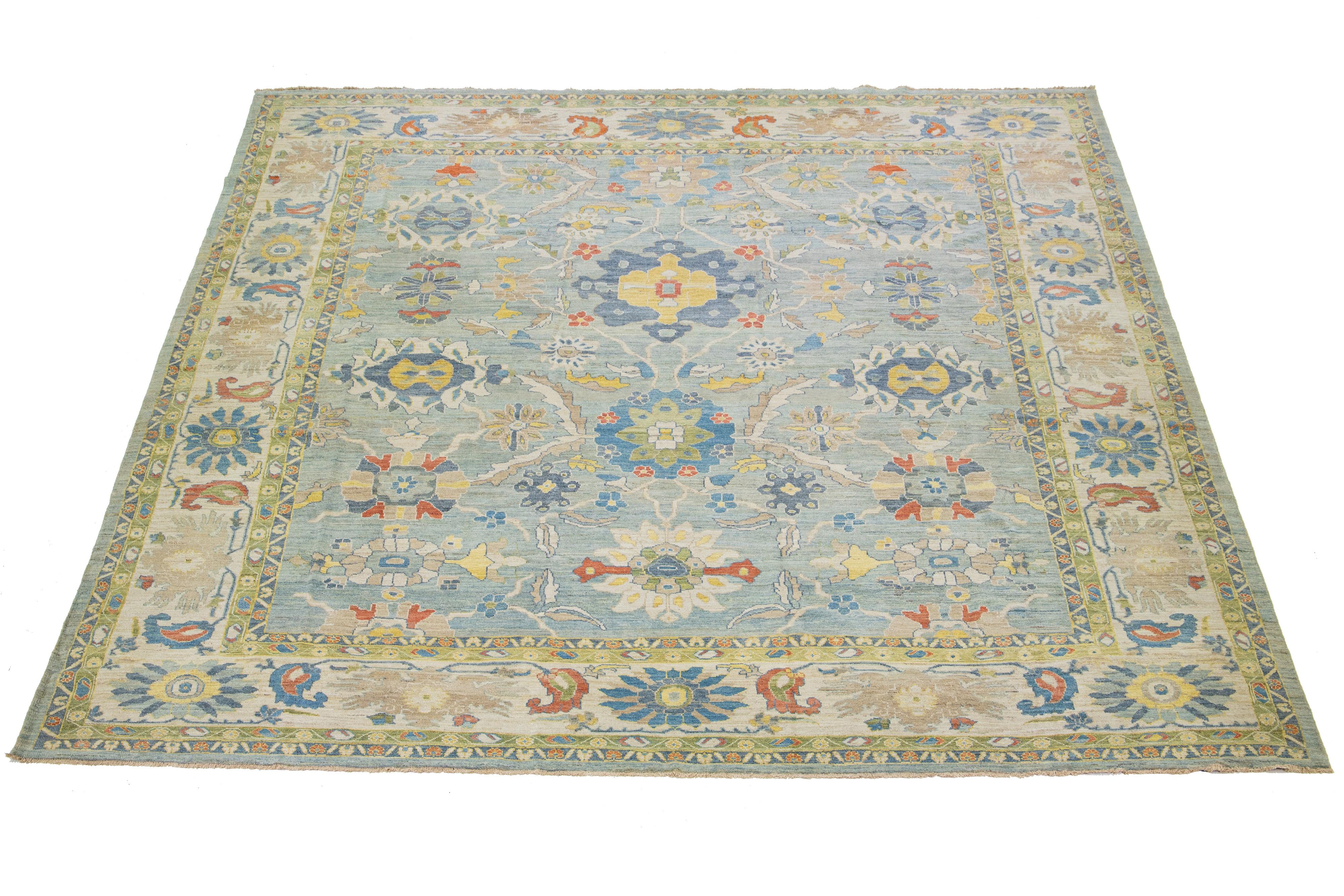 This stunning, hand-knotted Sultanabad rug features a modern design with a light blue base. The Persian rug is bordered with a beige frame and embellished with many colors that form an attractive floral pattern.

This rug measures 14'10