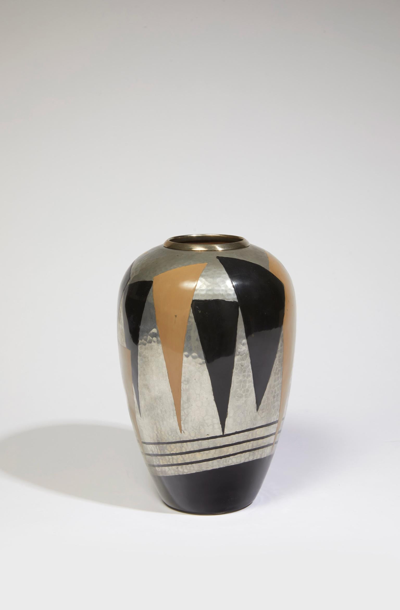 Vase in copperware and lacquer with black and gold triangles and lines on a metal background. Stamped Jean Dunand, artist's stamp JD on the underside.