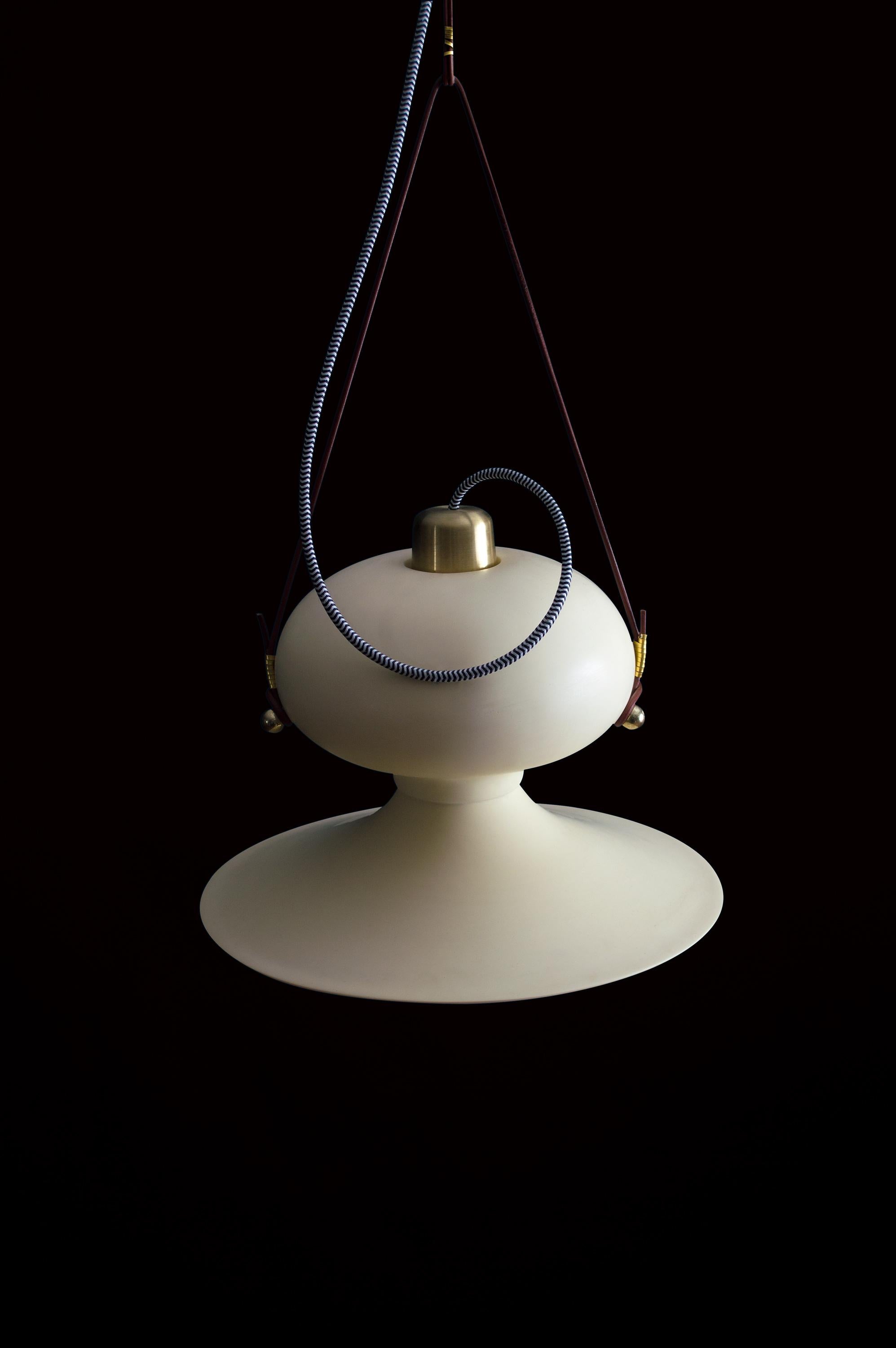 OVOIDE N.° 3 pendant by Acoocooro
Dimensions: Ø 40 x H 26 cm, leather cord length made to order.
Materials: Hand-cast resin sculptural pendant, brass accents, and round leather cord.

All our lamps can be wired according to each country. If sold to