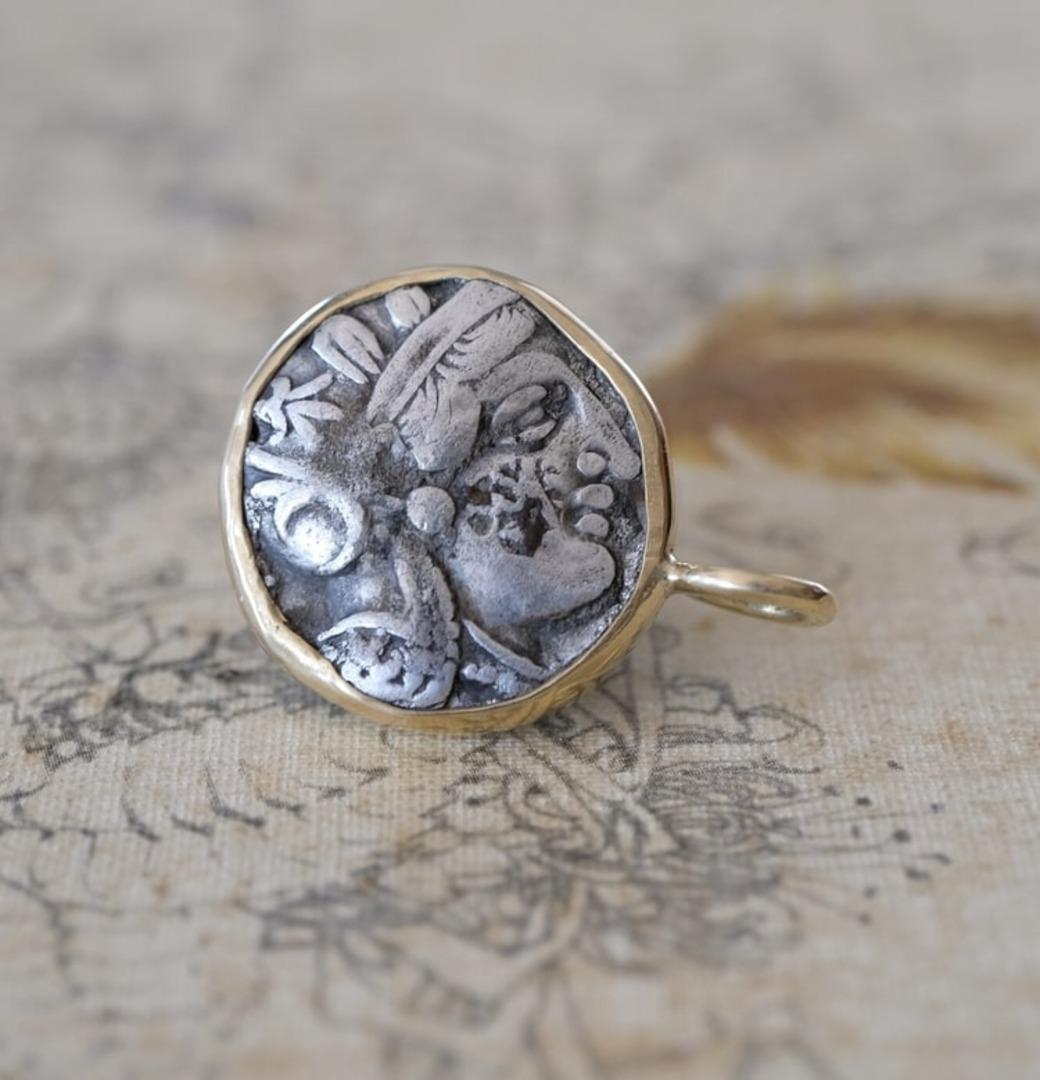 Read my blog post about Athens' owl coin: https://www. peregrinependants. com/blog/athens-owl-coin

To appreciate its size, the relief of the coin and the shape of the bail, see the picture showing the coin next to a US quarter. The coin was first