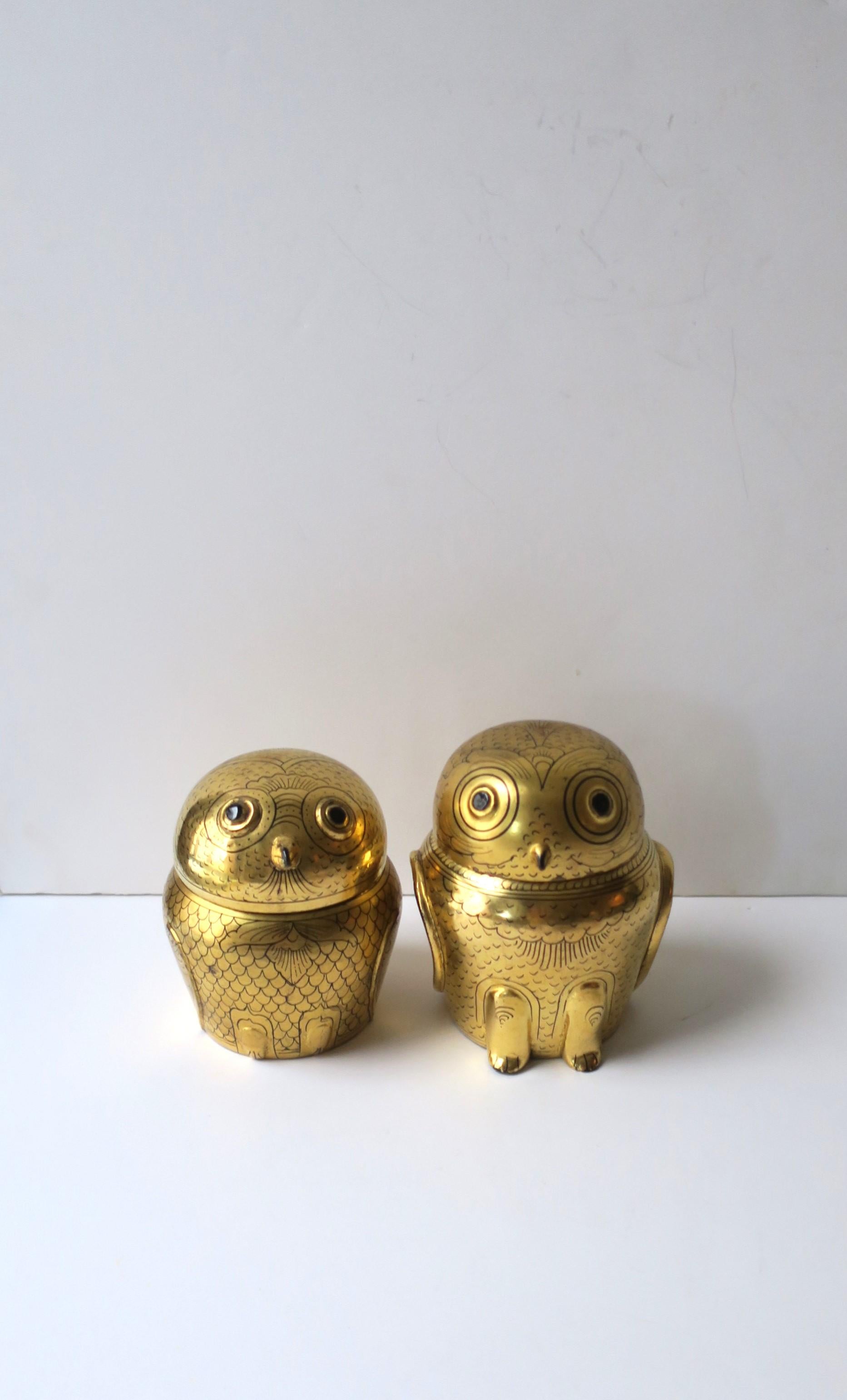 A set/pair of two (2) Burmese gold box owls, circa mid to late-20th century, 1980s, Burma. A beautiful set of two owl boxes with gold foil overlay on wood with black lacquer interior. Detailed eyes, beak, feet, and wings. Great decorative objects or