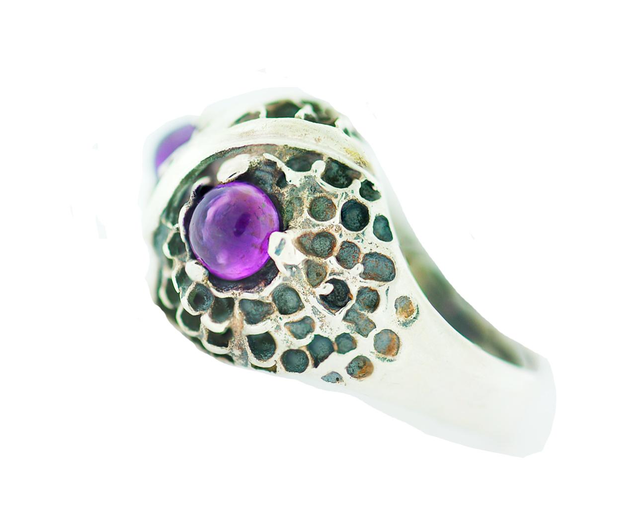 

Fun owl ring features two predominant amethyst colored eyes. The stones are purple colored and cabochon in shape. The ring measures .75 inches in diameter and .41 inches height.
This is a unisex worn ring and a great statement piece for an estate
