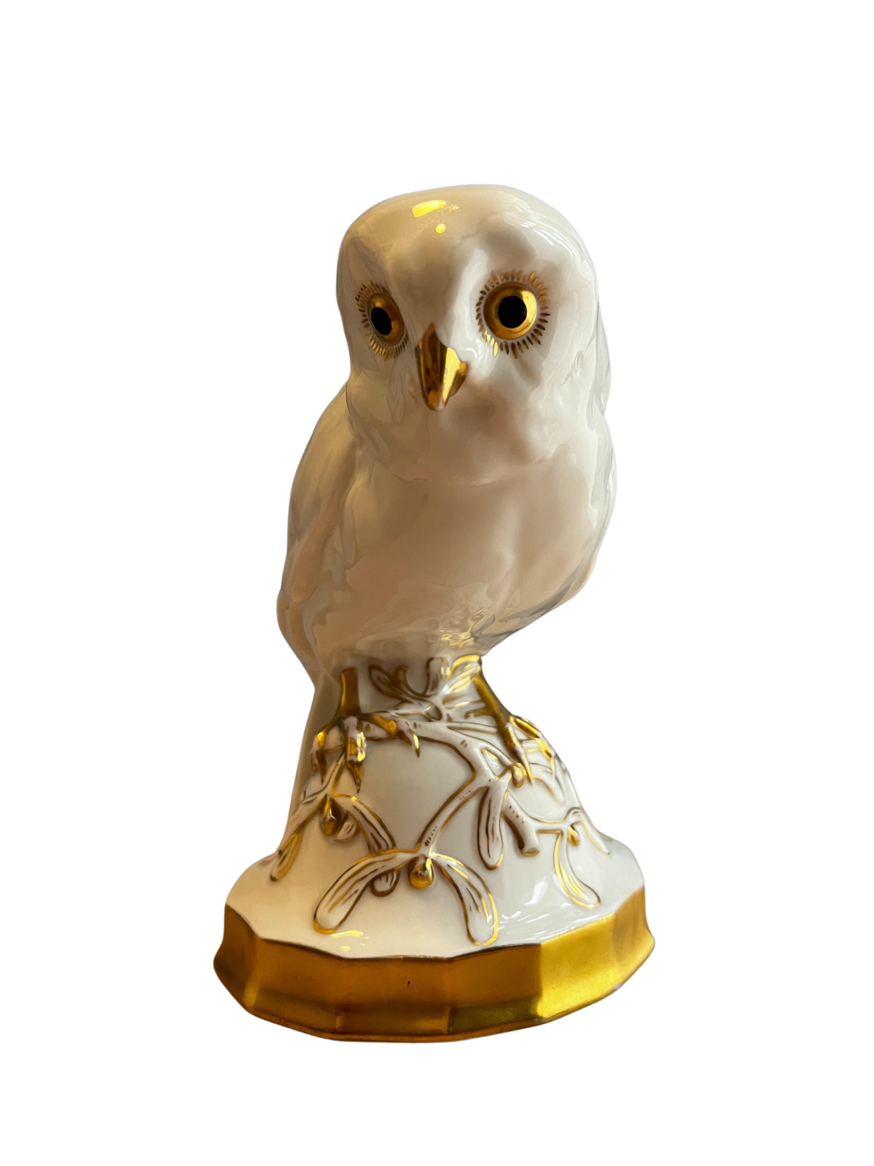 Wonderful perfectly preserved owl sculpture on a pedestal, made of white porcelain, partly gilded, handmade in the world famous German porcelain manufactory Hutschenreuther.

The polygonal pedestal has a gilded base, on which lie mistletoe branches,