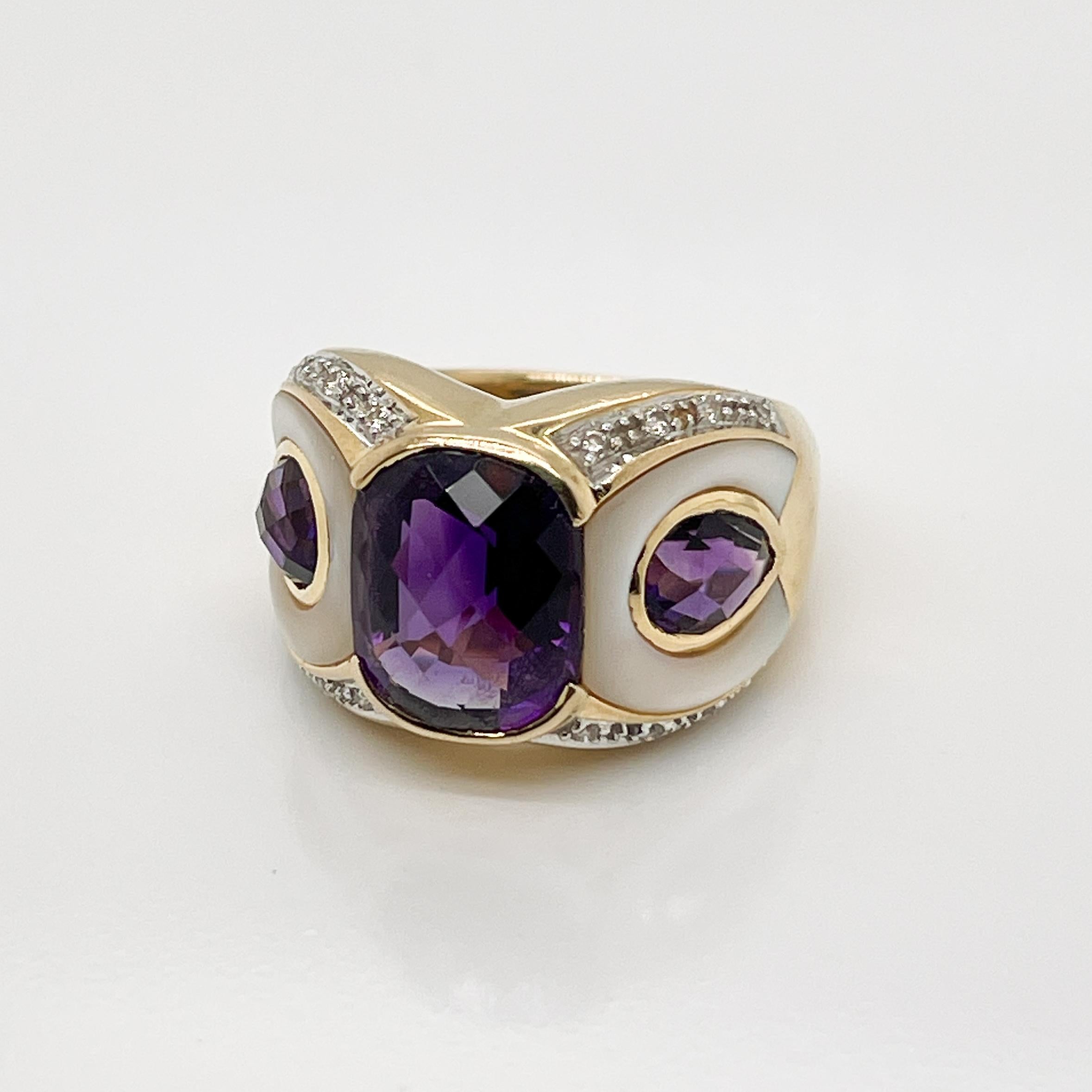 A very fine vintage figural owl or parrot ring. 

Set with checkerboard-cut cushion and pear shaped amethysts for a beak and eyes and flanked by bezel set mother-of-pearl and round brilliant cut prong-set accent diamonds.

Simply a wonderful