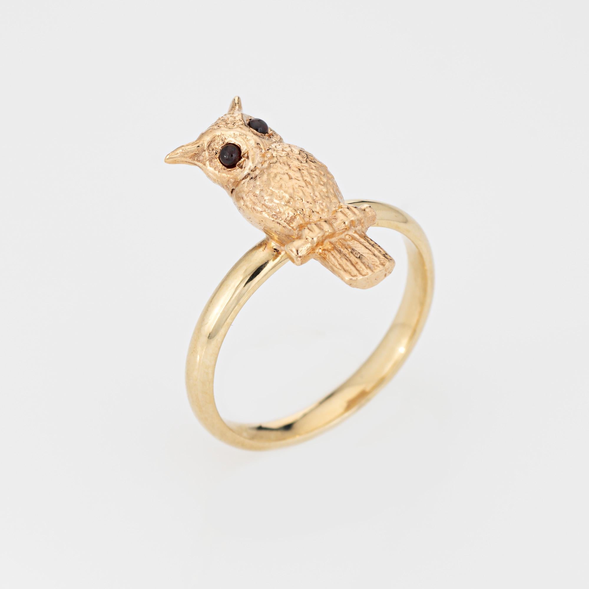 Stylish owl ring set with garnet set eyes, crafted in 14 karat yellow gold. 

Two small cabochon cut garnet measure approx. 1mm. The garnets are in very good condition and free of cracks or chips. 

The beautifully detailed owl is perched on the