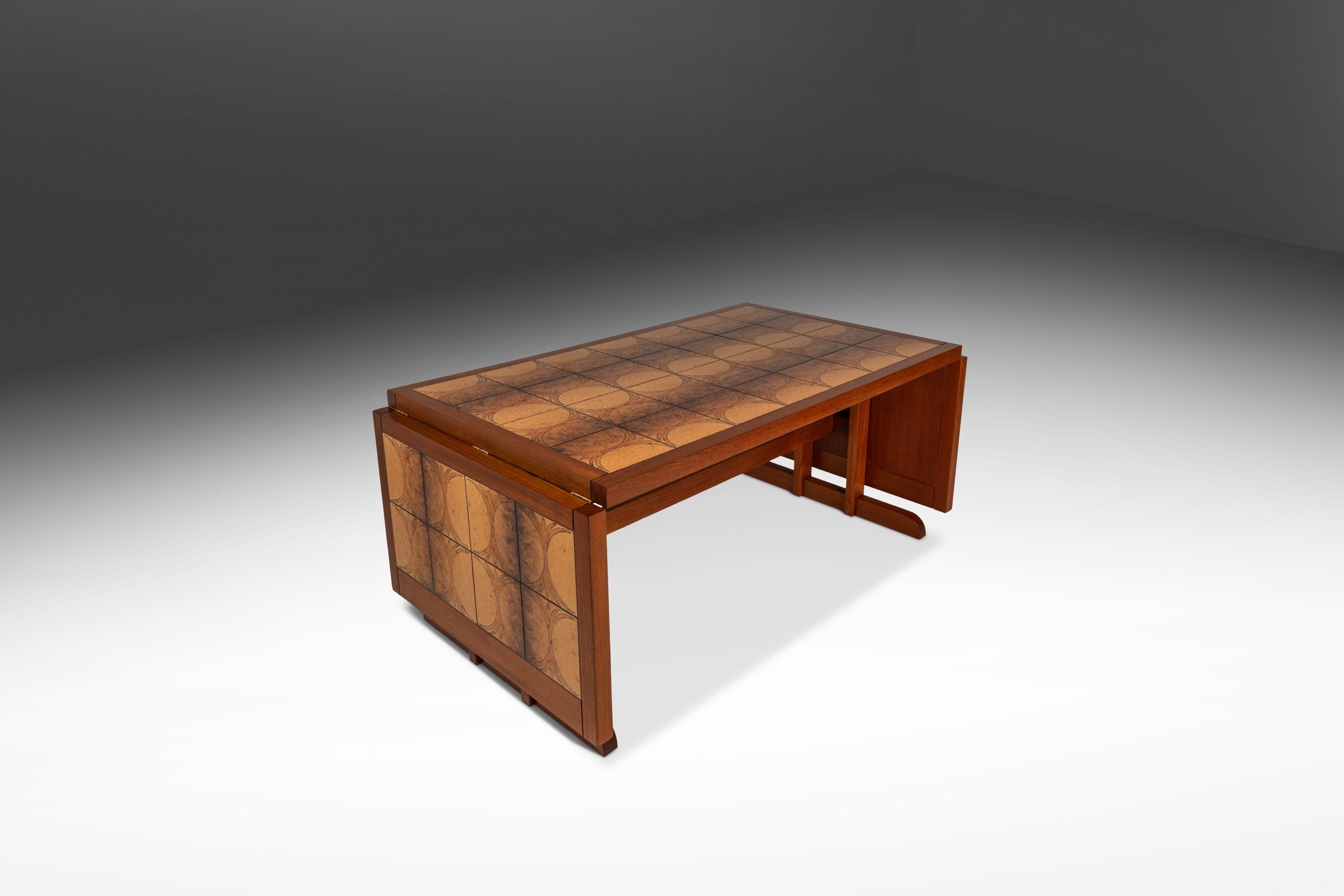 This striking Mid-Century teak drop leaf table, designed by Trion in the 1970s, embodies the bold geometric flair of the Ox Art style with a fully restored finish. Crafted from rich teak, the table features a warm, honey-toned surface that