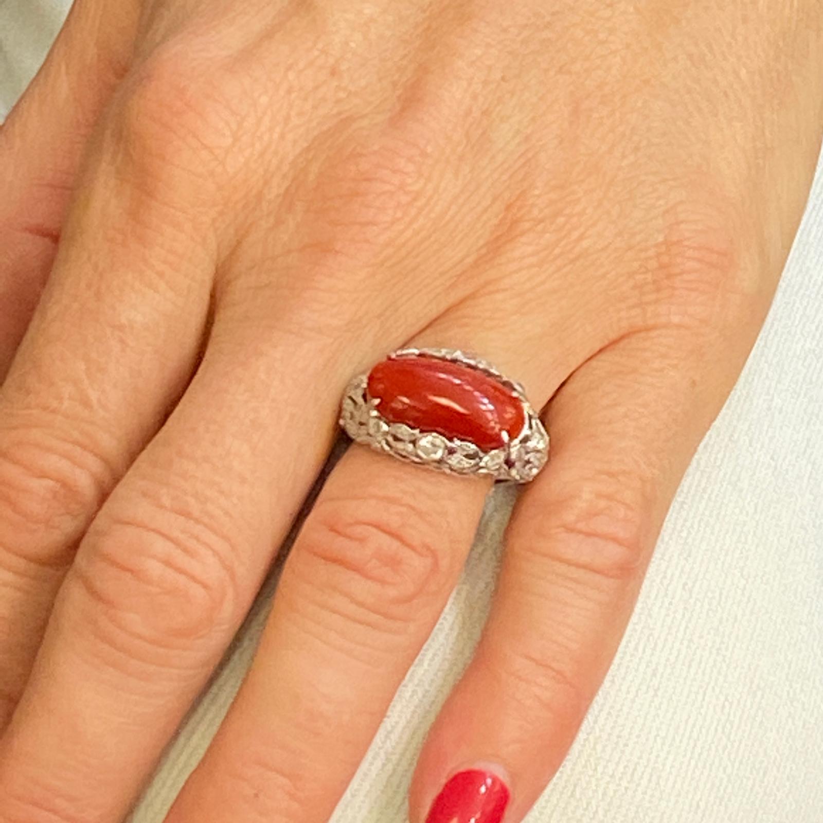 Gorgeous Ox Blood Coral and Old European Cut Diamonds shine in this Original Art Deco Ring. The open filigree diamond shank is beautifully crafted and set with a 10 x 20mm coral gemstone set east to west. There are approximately 1.00 carat total