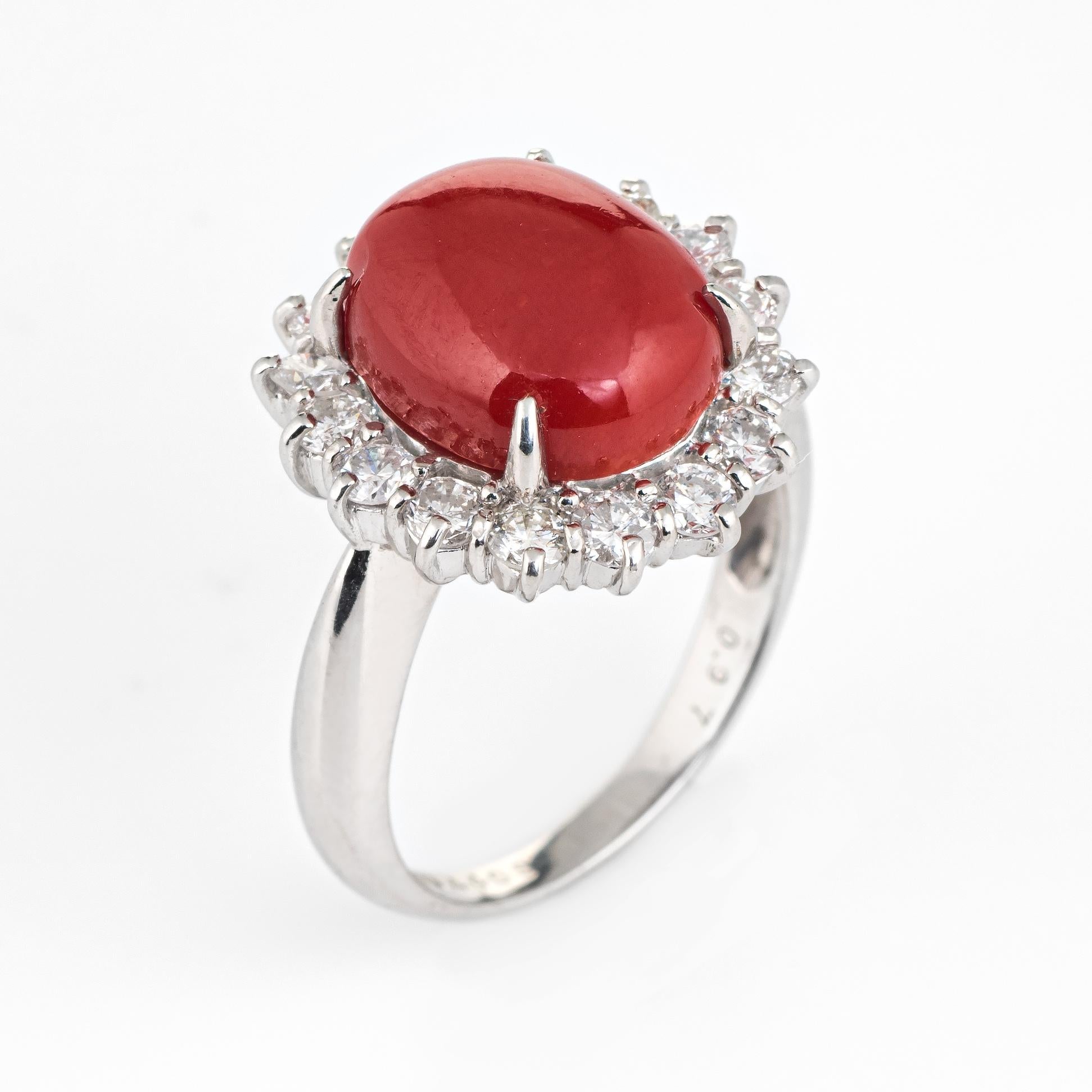 Elegant estate ox blood red coral & diamond ring crafted in 900 platinum. 

Cabochon red coral measures 12mm x 10mm (estimated at 4.40 carats), accented with an estimated 0.97 carats of diamonds (estimated at G-H color and VS2-SI1 clarity). Note: