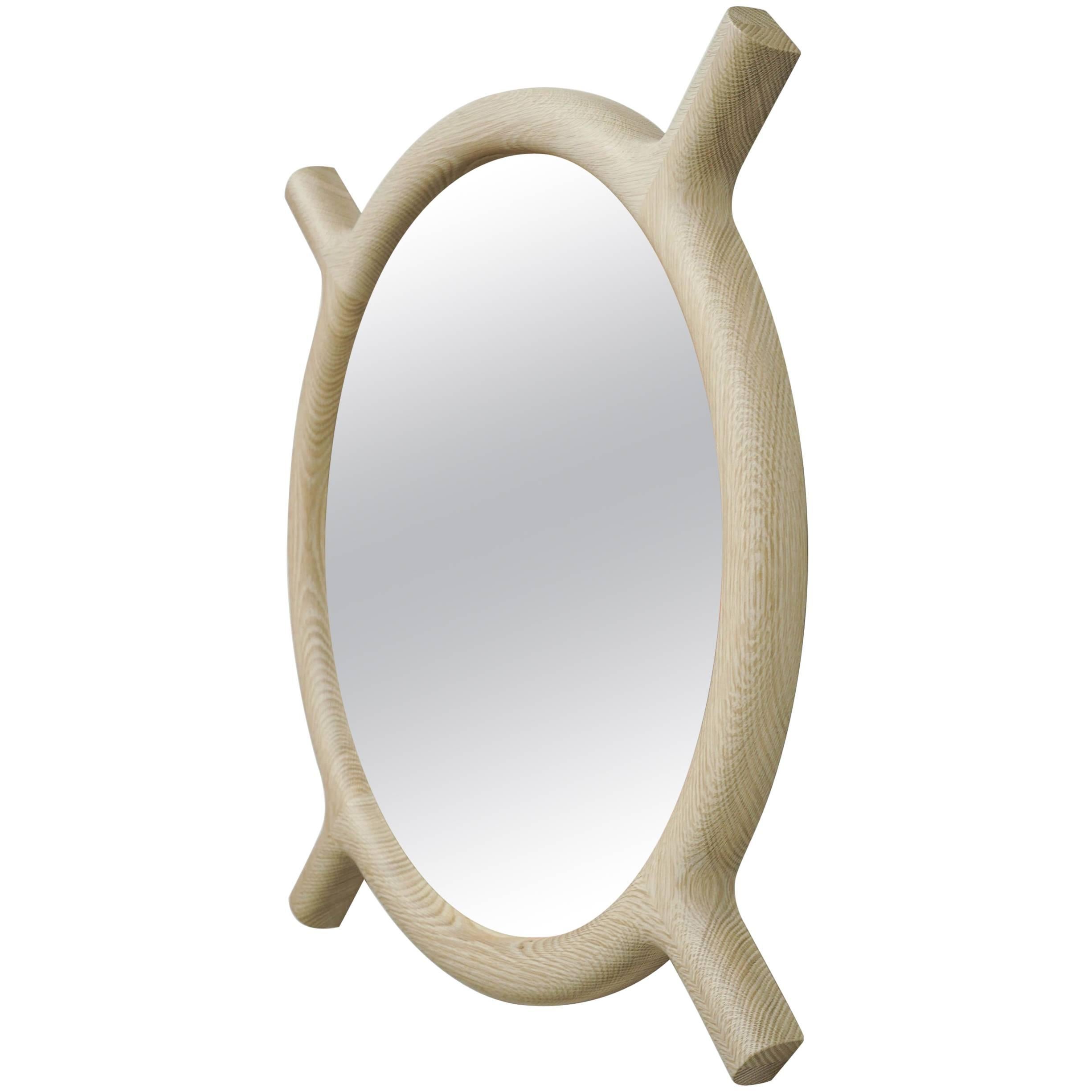 Round wall mirror that may be hung in two positions. Walnut is available now, but also made to order in bleached rift white oak and oxidized rift white oak.

          