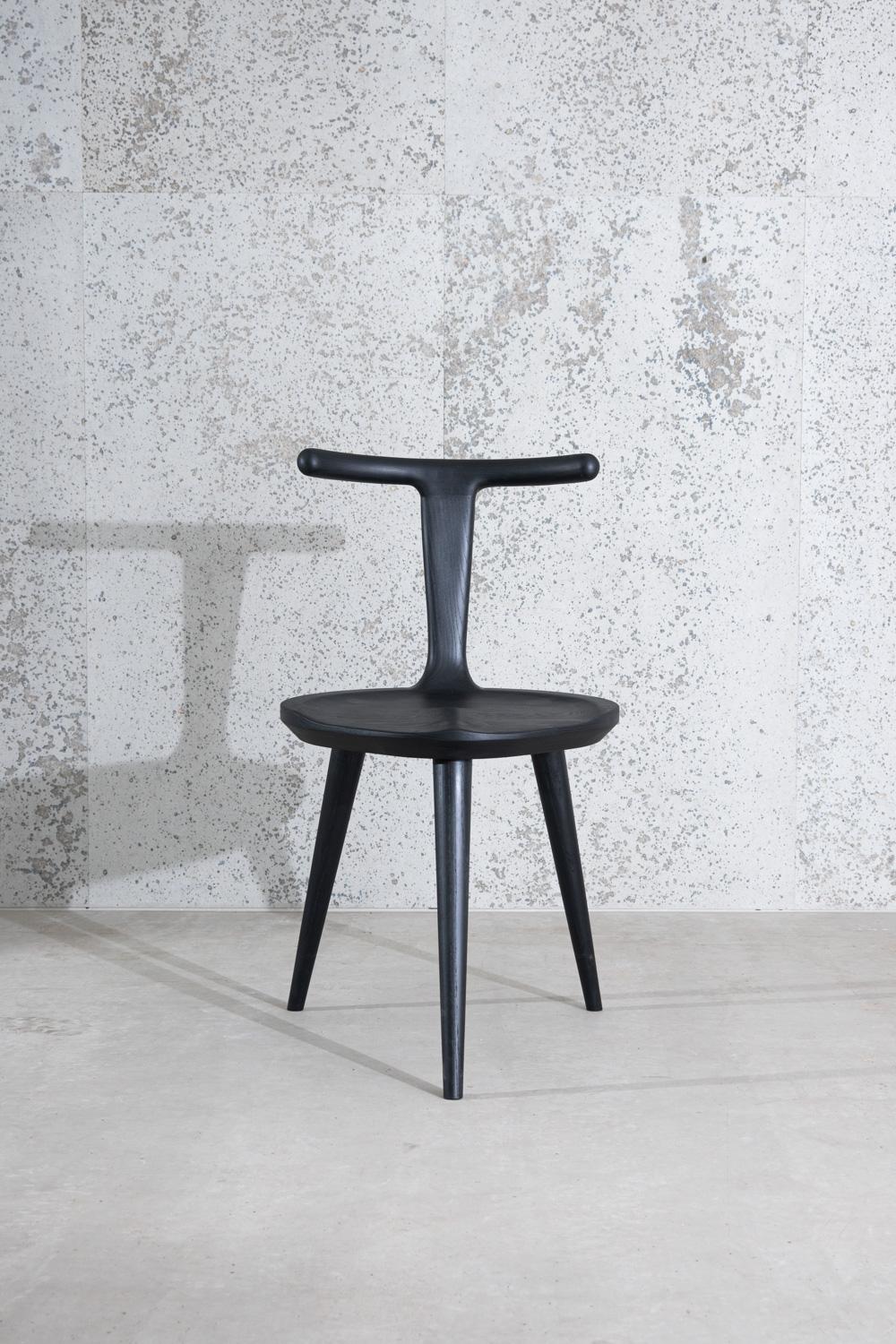 This listing includes one three-legged Oxbend chair in American ash hardwood stained charcoal black.

The original inspiration for the entire Oxbend collection, this modern dining chair was designed by Justin Nelson for Fernweh Woodworking. Born