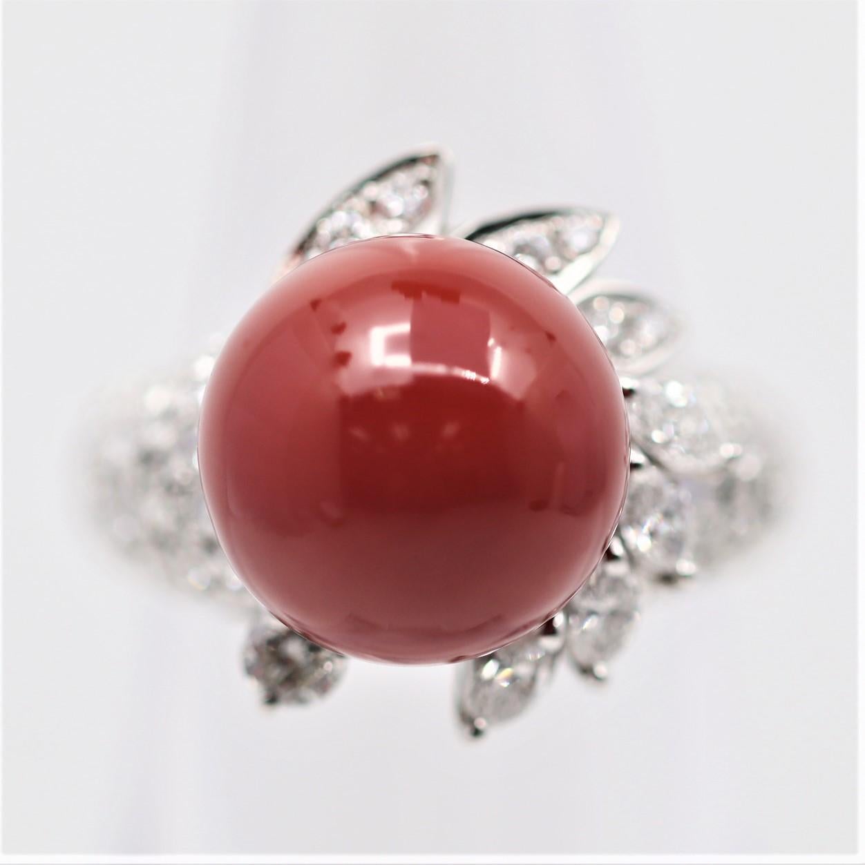 A sleek and stylish ring featuring a 12mm coral with the ideal bright red color, known as “oxblood” in the trade. It is complemented by 0.80 carats of round brilliant and marquise-shape diamonds adding sparkle and brilliance to the ring.