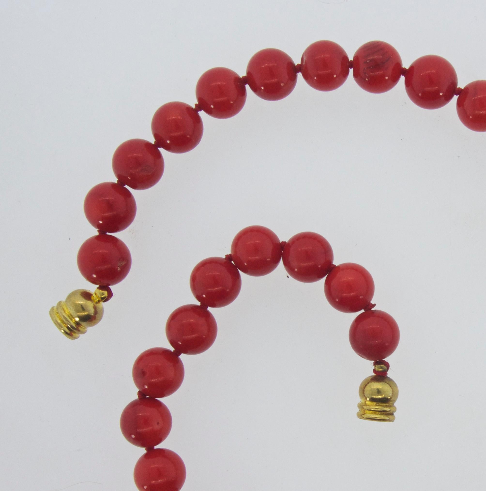 Red coral (referred to as Oxblood) bead necklace with 41 round 10 mm coral beads knotted and strung on red silk.  This strand is 18 inches long.  The coral is well matched with slight graining apparent and very slight color striations and very