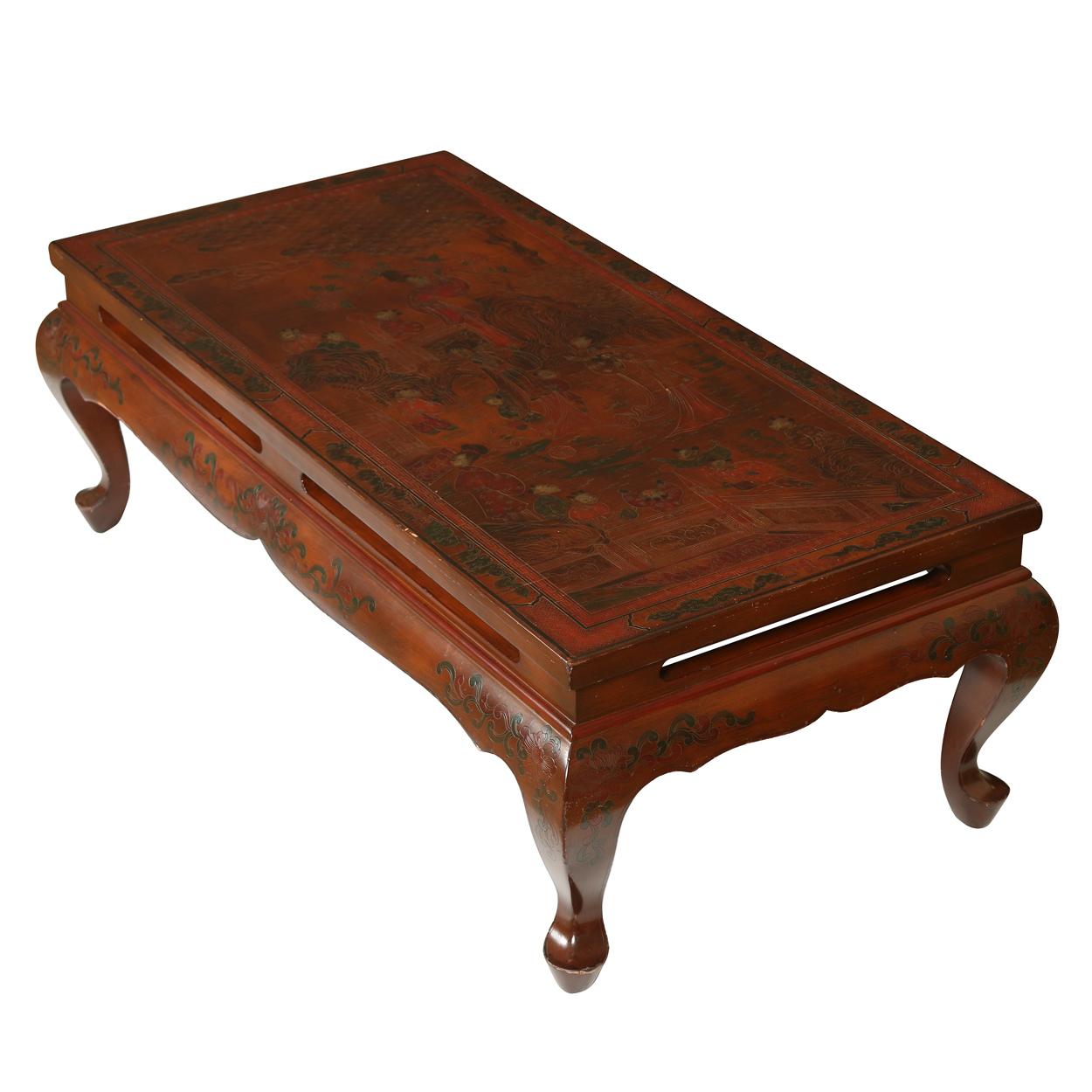 Chinoiserie painted table with figural scene on oxblood lacquered low table with curved apron and cabriole legs.