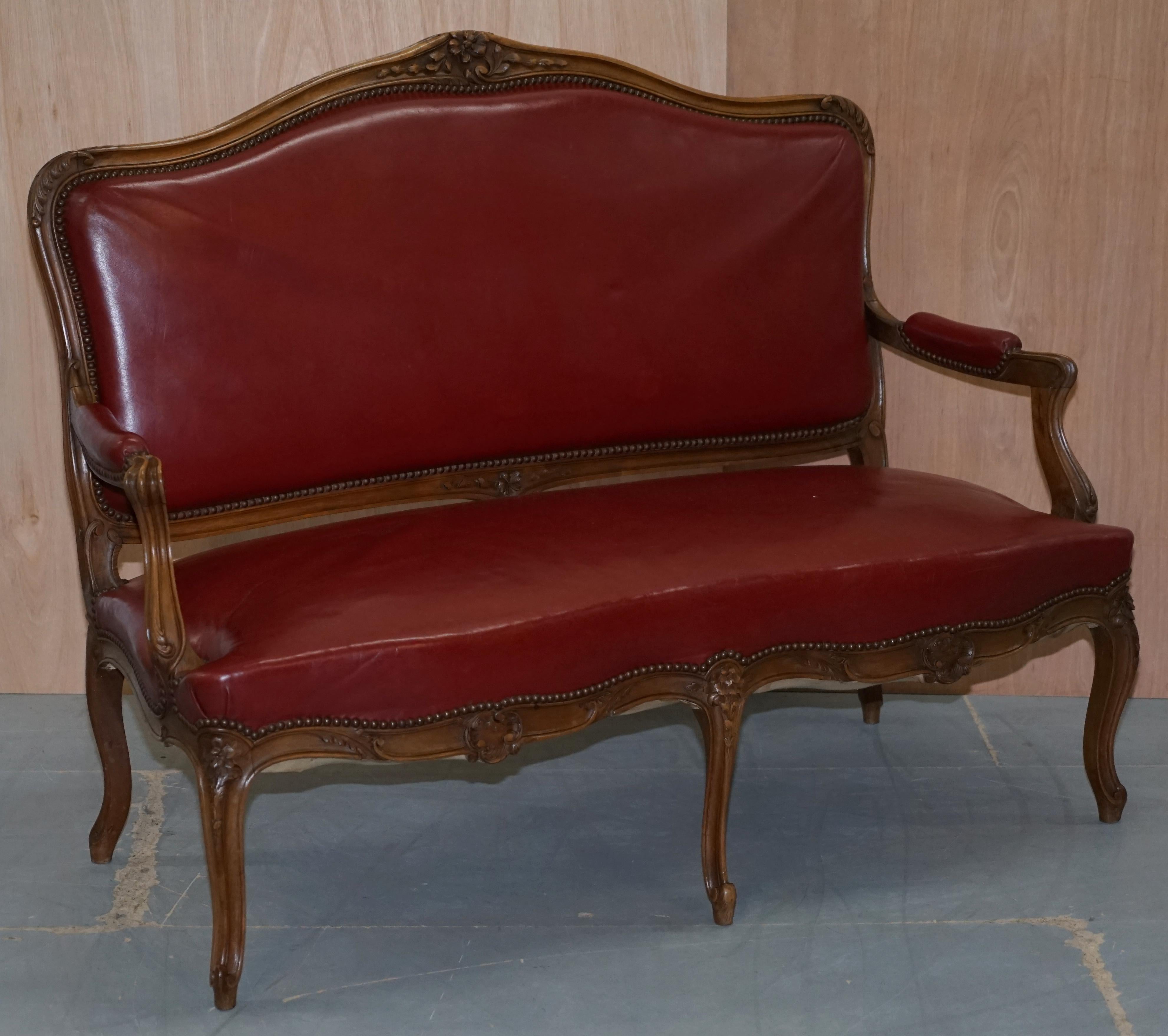 We are delighted to offer for sale this Oxblood leather walnut framed French XV style suite

A very good looking and well made salon suite, the Walnut frames have been beautifully hand carved and look lovely from all angles, the leather upholstery