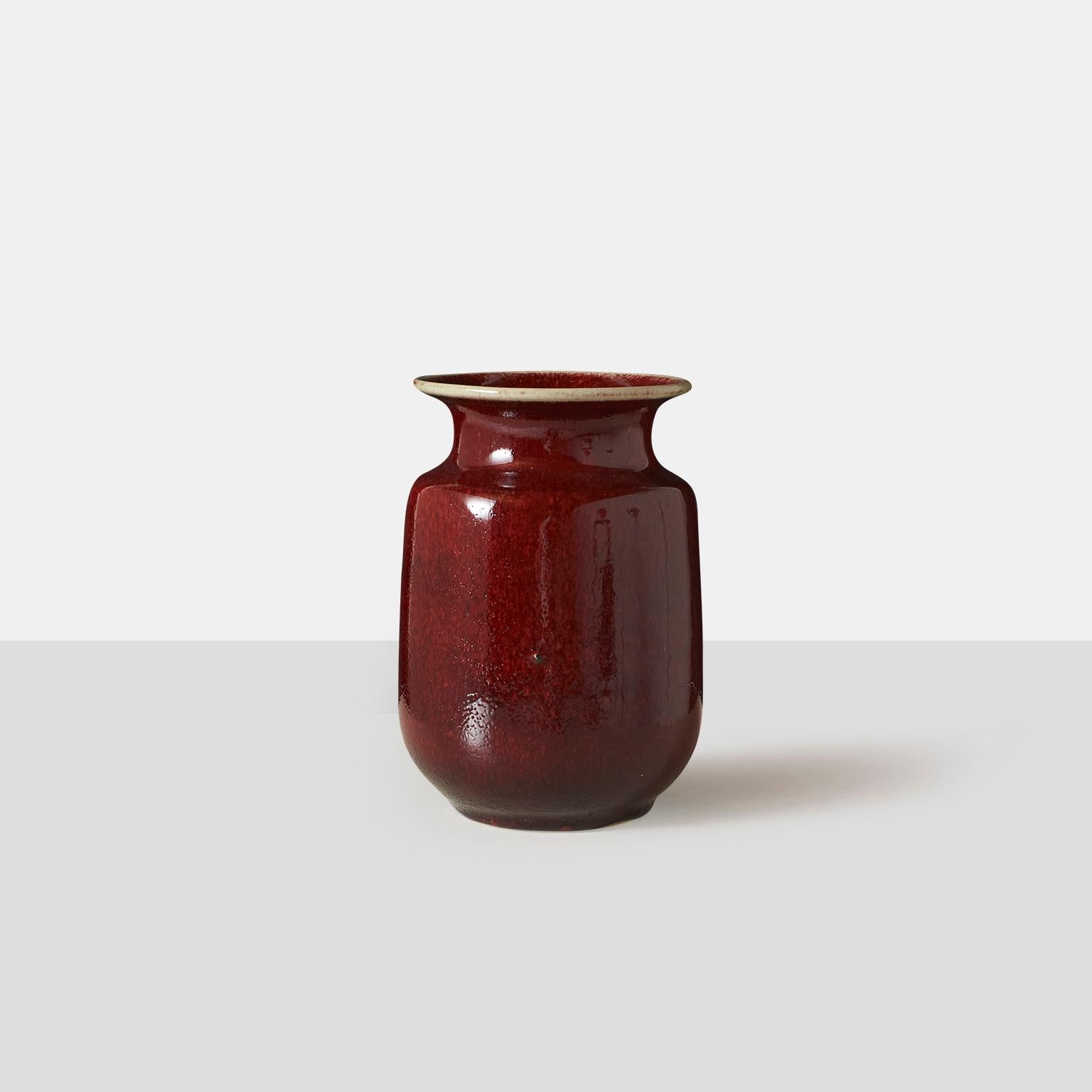 A stoneware vase with a mottled oxblood glaze and contrast natural stone rim. One small scratch near the base. No chips or marks.
Etched on base: K Bolinder Höganäs 1/197