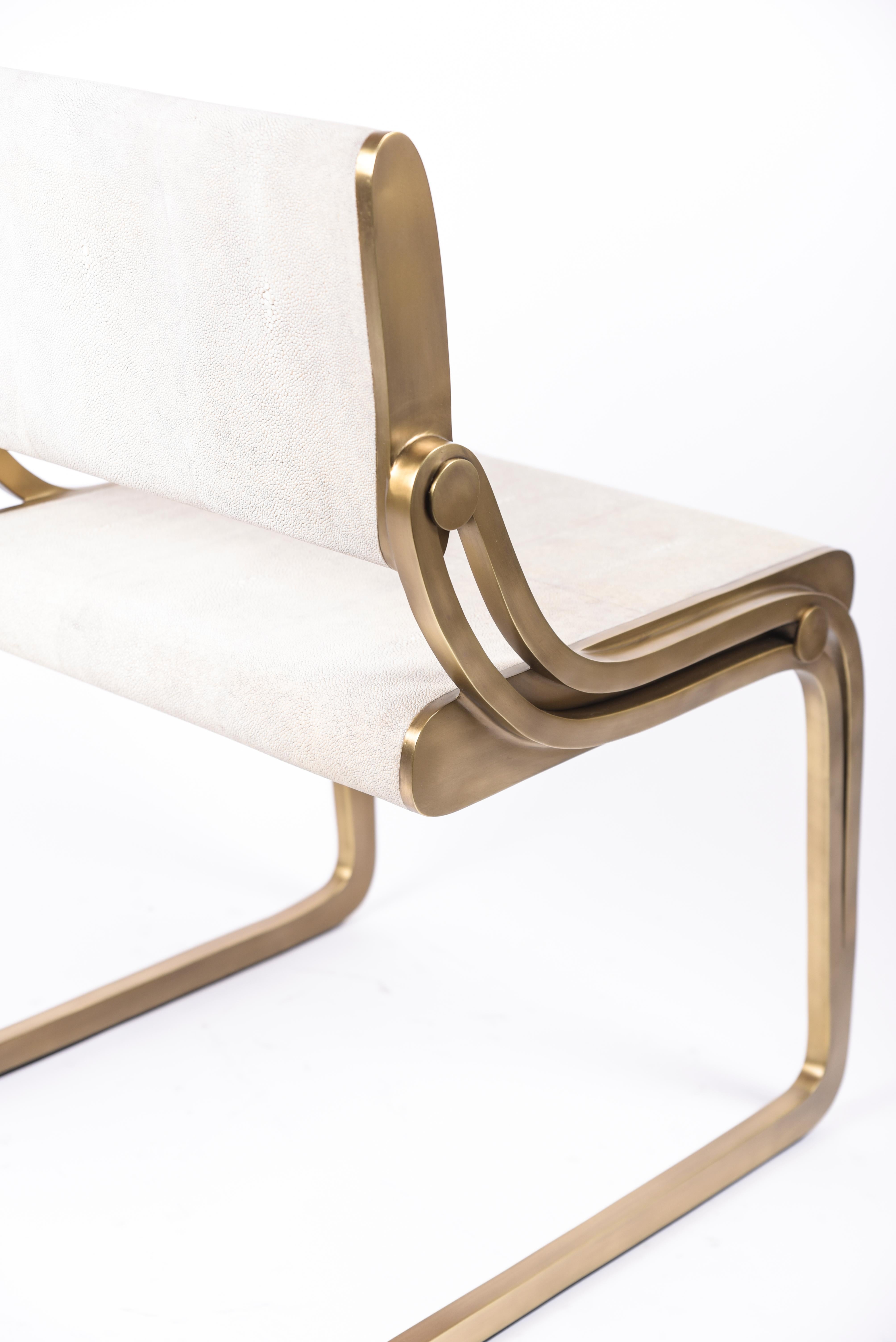 The Oxford chair by R&Y Augousti is a sophisticated piece that provides comfort, whilst retaining its elegant and luxurious aesthetic. This piece is inlaid in cream shagreen, with a bronze-patina brass frame. Available with fur upholstery, see