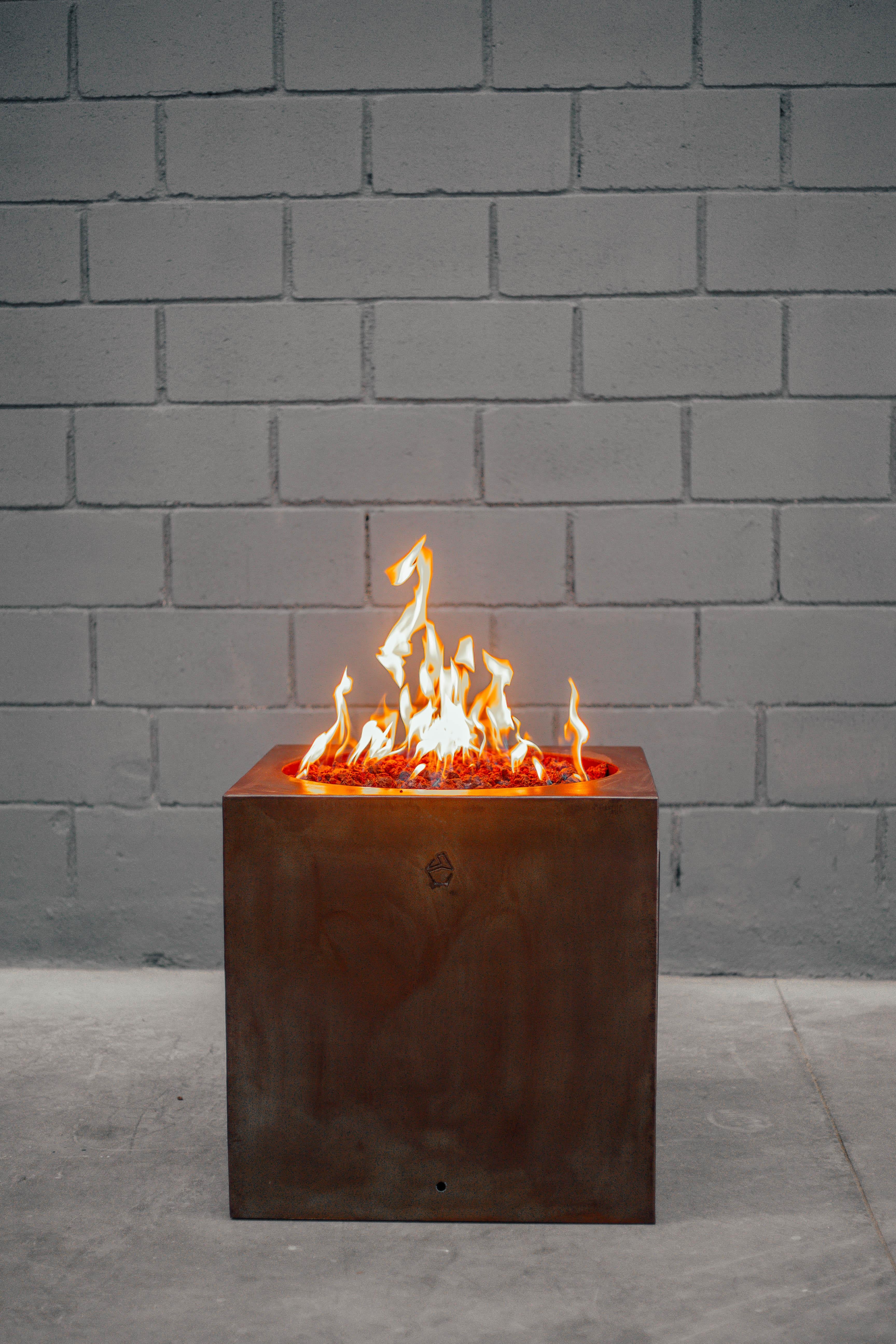 Oxidazed cubus firepit by Andres Monnier.
Dimensions: 60 x 60 x H 60 cm.
Materials: stainless steel. 
Technique: polished stainless steel. 

The design of this collection is based on geometry, where we unite different basic shapes to create