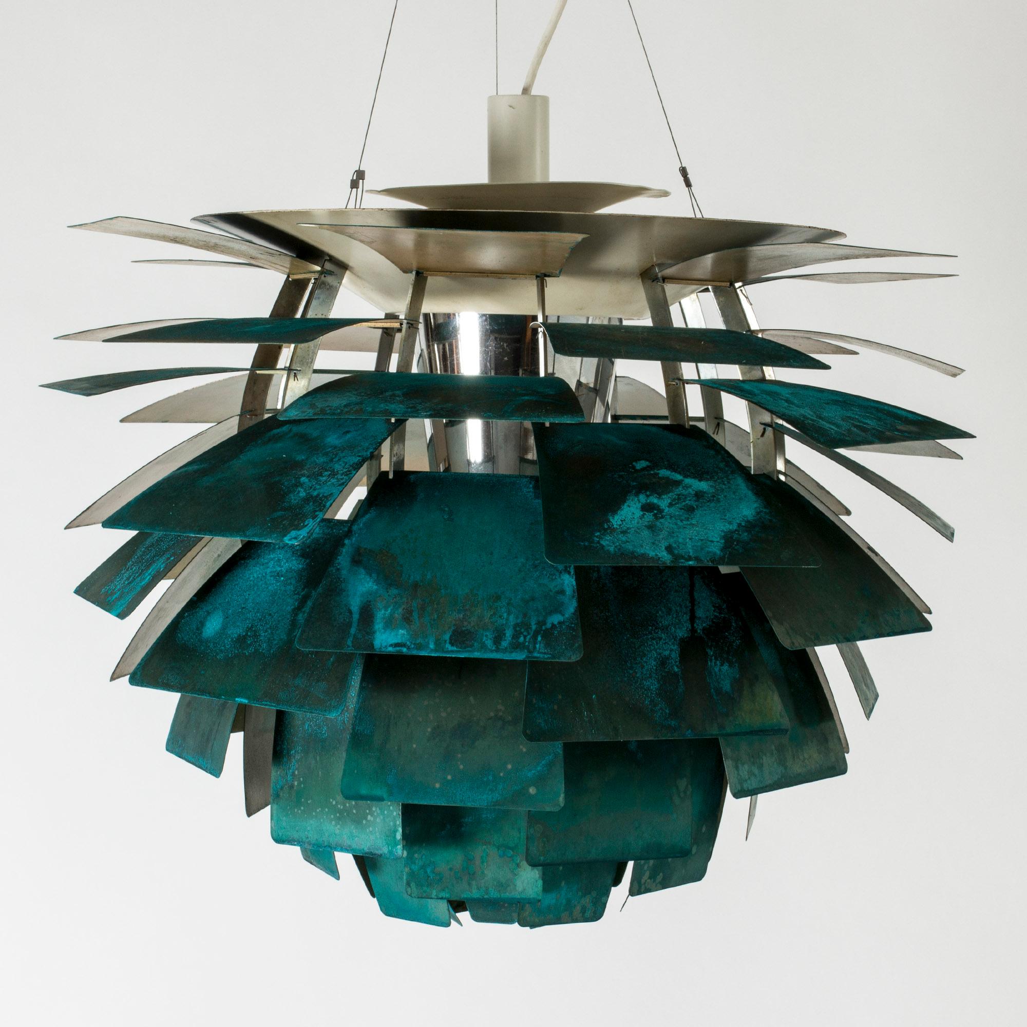 Striking “Kotten” or “Artichoke” pendant light by Poul Henningsen, made from copper. The copper is beautifully patinated in a vibrant verdigris green, with varying nuances. The ingenious design from 1958 lets light out in a fascinating way and this