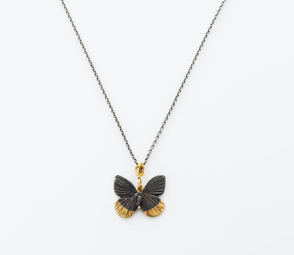 James Banks's signature butterfly necklace features a Baby Asterope butterfly with a hinge at the center to allow movement of the wings, set in Oxidized Sterling Silver with 18k Yellow Gold inlay at the tips, 18k yellow gold hook and crown, hung on
