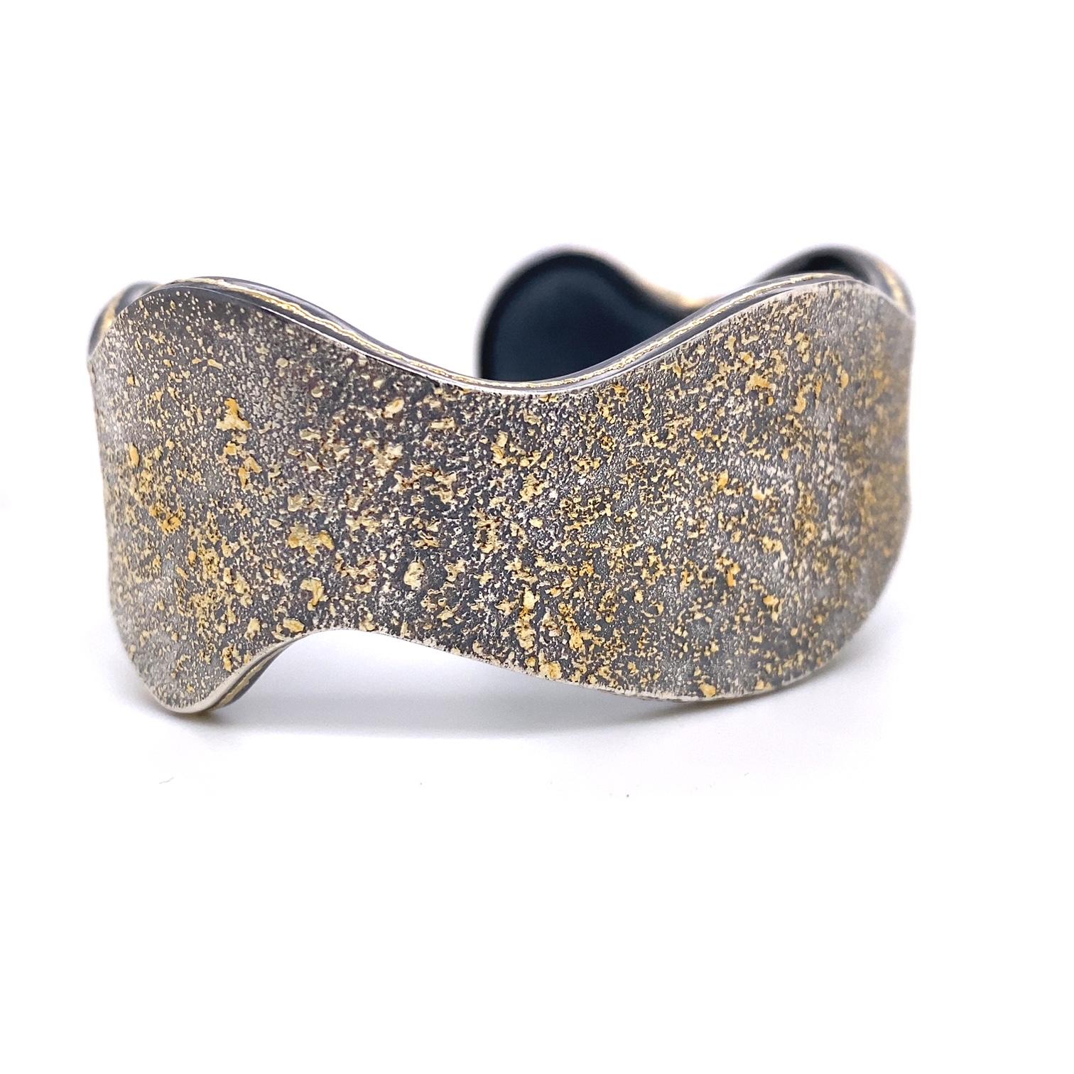 An oxidized sterling silver cuff with 24k gold fairy dust and 18k yellow gold accents. Titled 