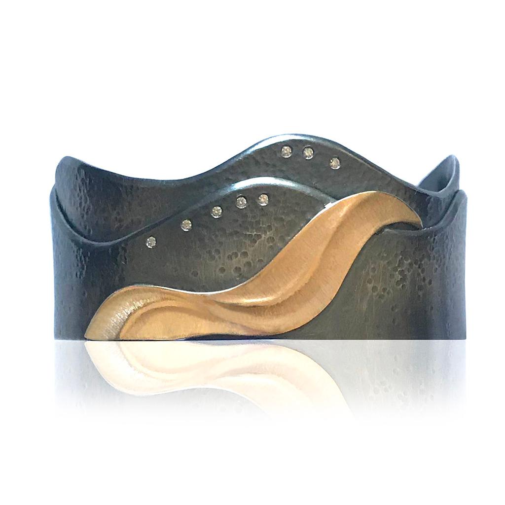 Keiko Mita's Medi Shoreline Cuff is inspired by waves crashing on the shoreline of the small Japanese island where she was born. Handmade from 14 Karat Yellow Gold and Oxidized Sterling Silver, eight small Diamonds (total weight 0.08 Carats) are