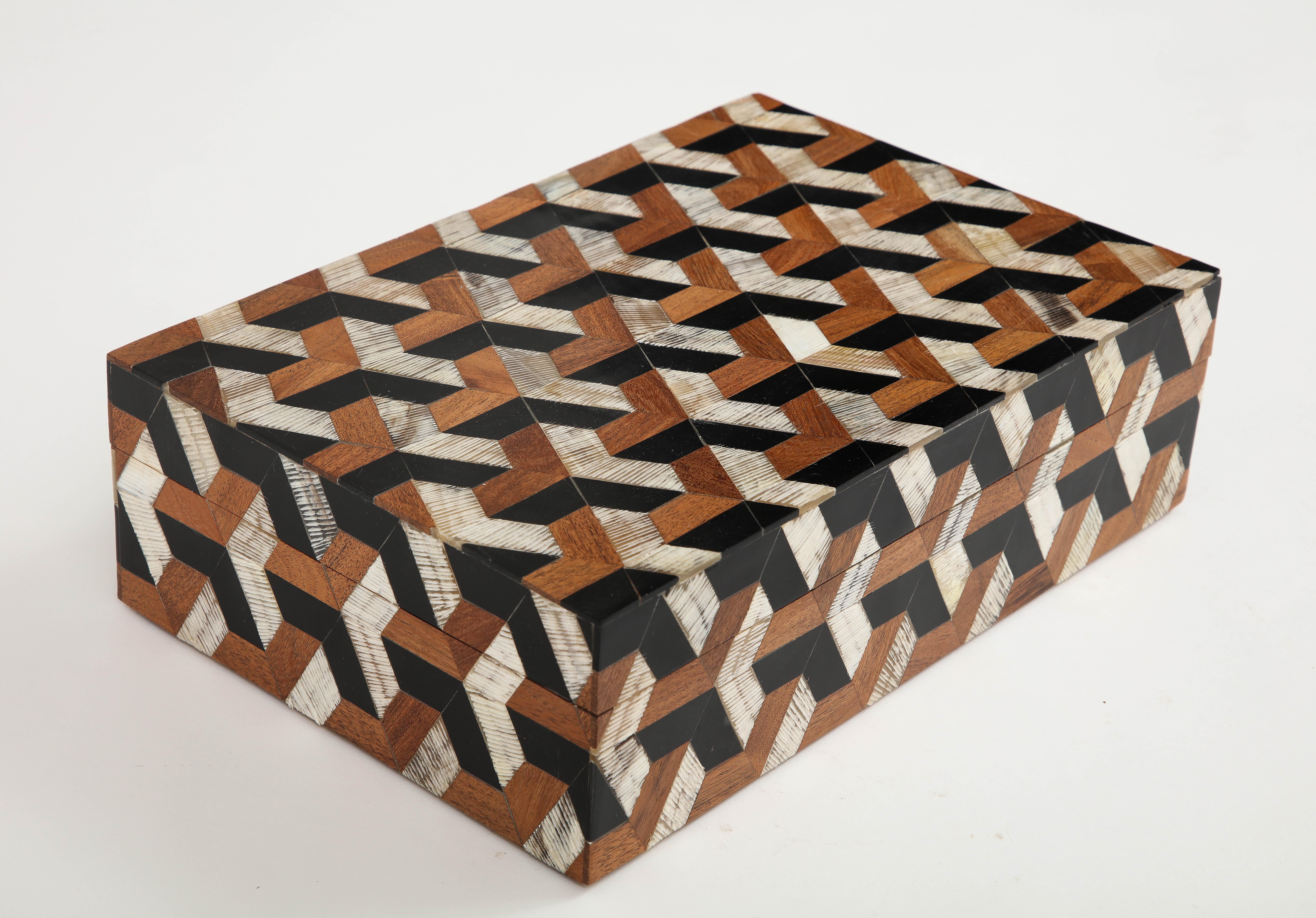 Hand made decorative keepsake box featuring a Goyard inspired pattern. Hand incised horn pieces add a uniqueness texture. A great addition to any coffee table or desk. Measures: 12x8.