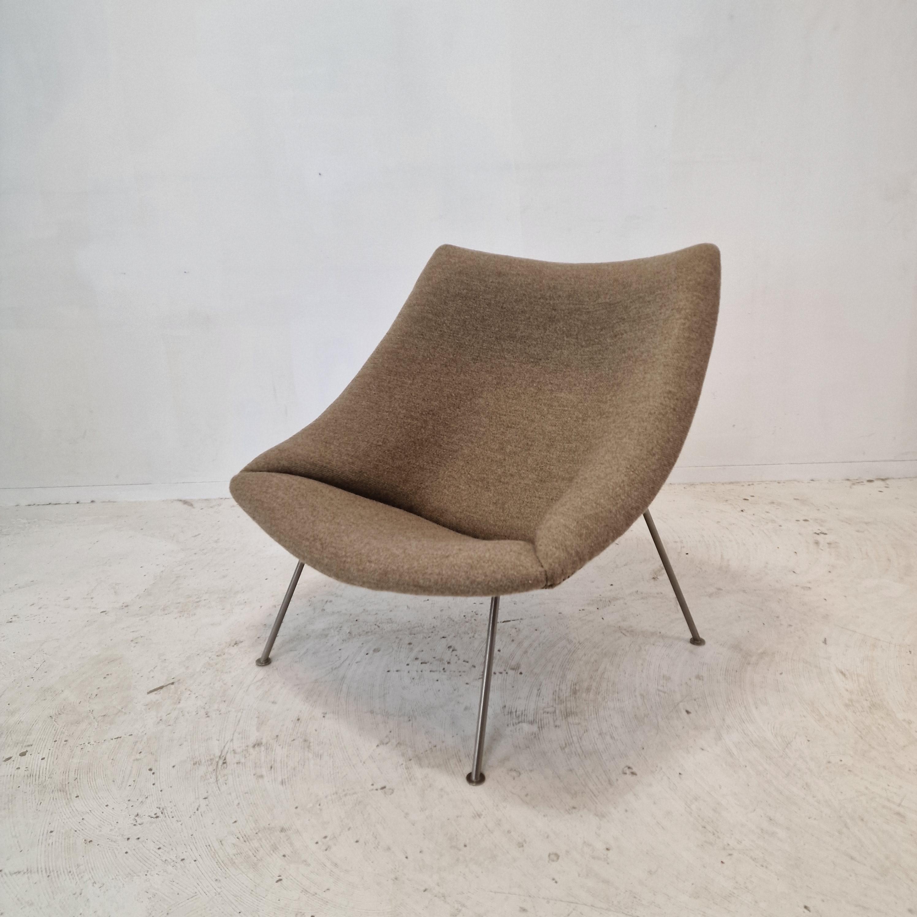 A beautiful Artifort Oyster chair.  

This very comfortable chair is designed by Pierre Paulin and fabricated by Artifort.  
This particular piece is manufactured in the 60's it has nickel metal legs.

It is just restored with new fabric and new