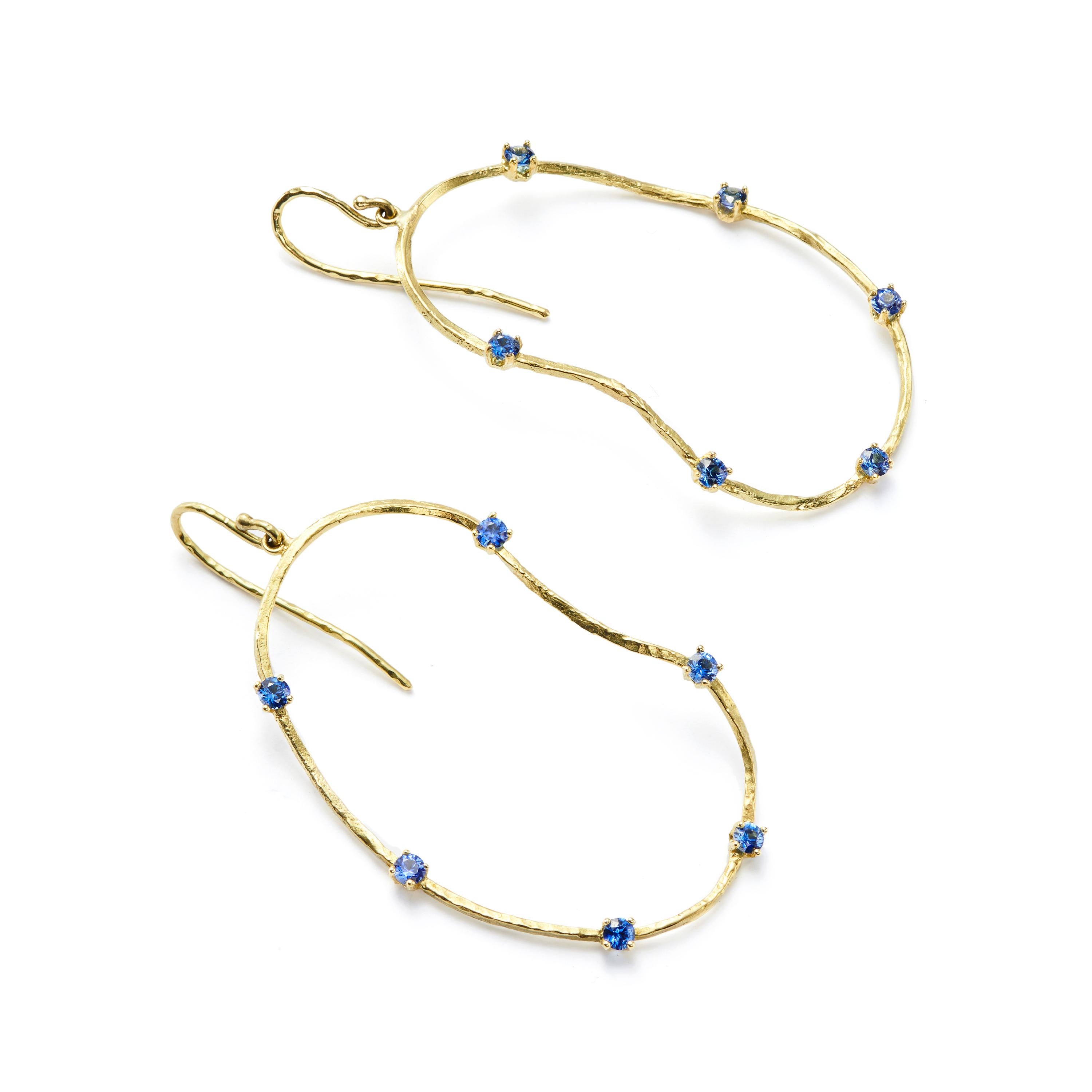 Our oysters with a twist feature brilliant cut, bright blue Sapphires, sprinkled on 18 Karat Gold shell-inspired earrings. The perfect serving of style and sophistication. Lightweight, these are perfect as an everyday earring.

Sapphires: 0.35