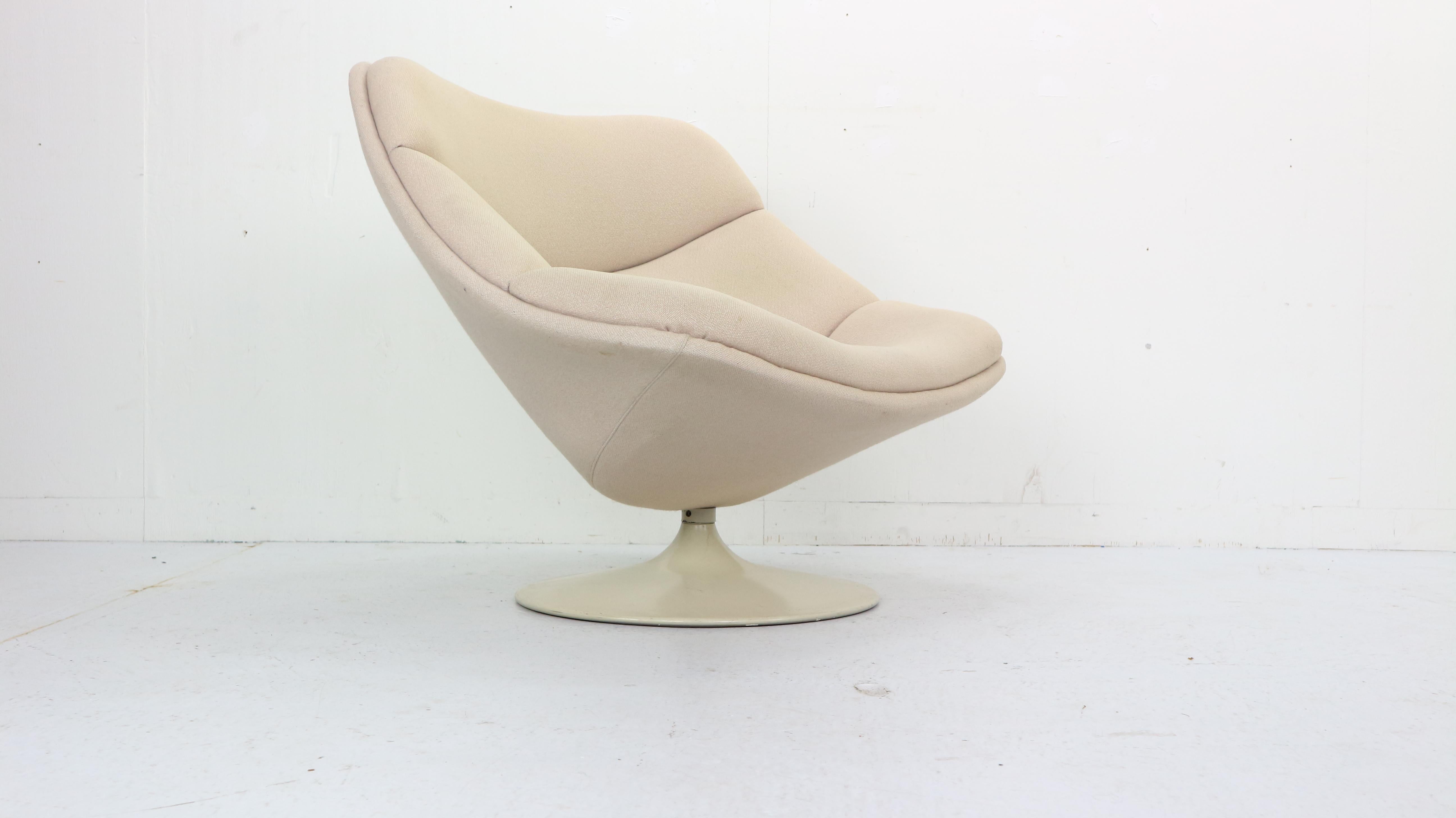 This lounge chair was designed by Pierre Paulin in 1961 for Artifort manufacture fabric, Netherlands. 
Model number- F557.
It's the first edition of the Oyster Chair and was produced until 1965, making it rare and unique vintage furniture