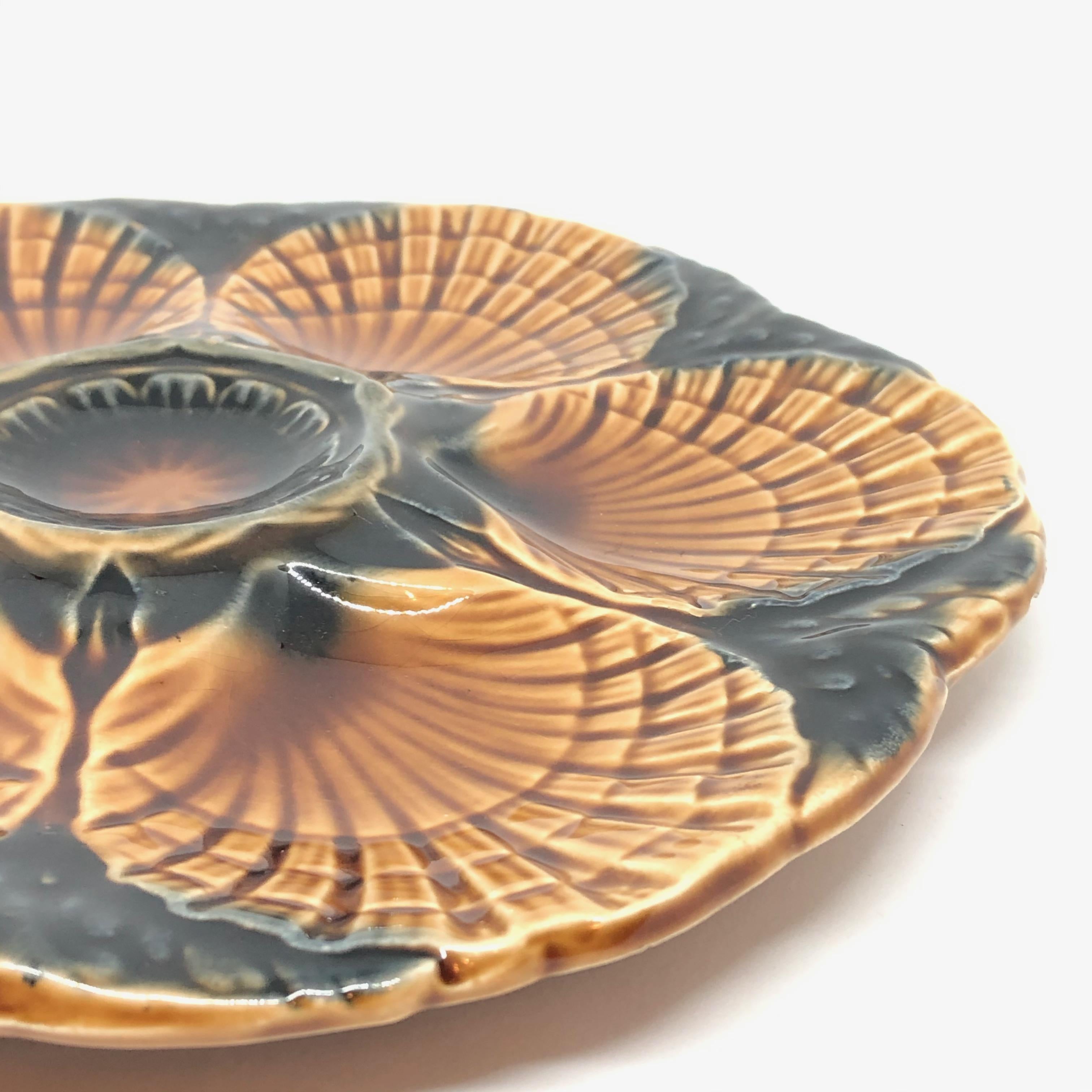 This beautiful oyster plate features 6 wells for oysters. It is marked at the back. Nice addition to your table or just to display. Small chip at the backside, not visible from the front.
 