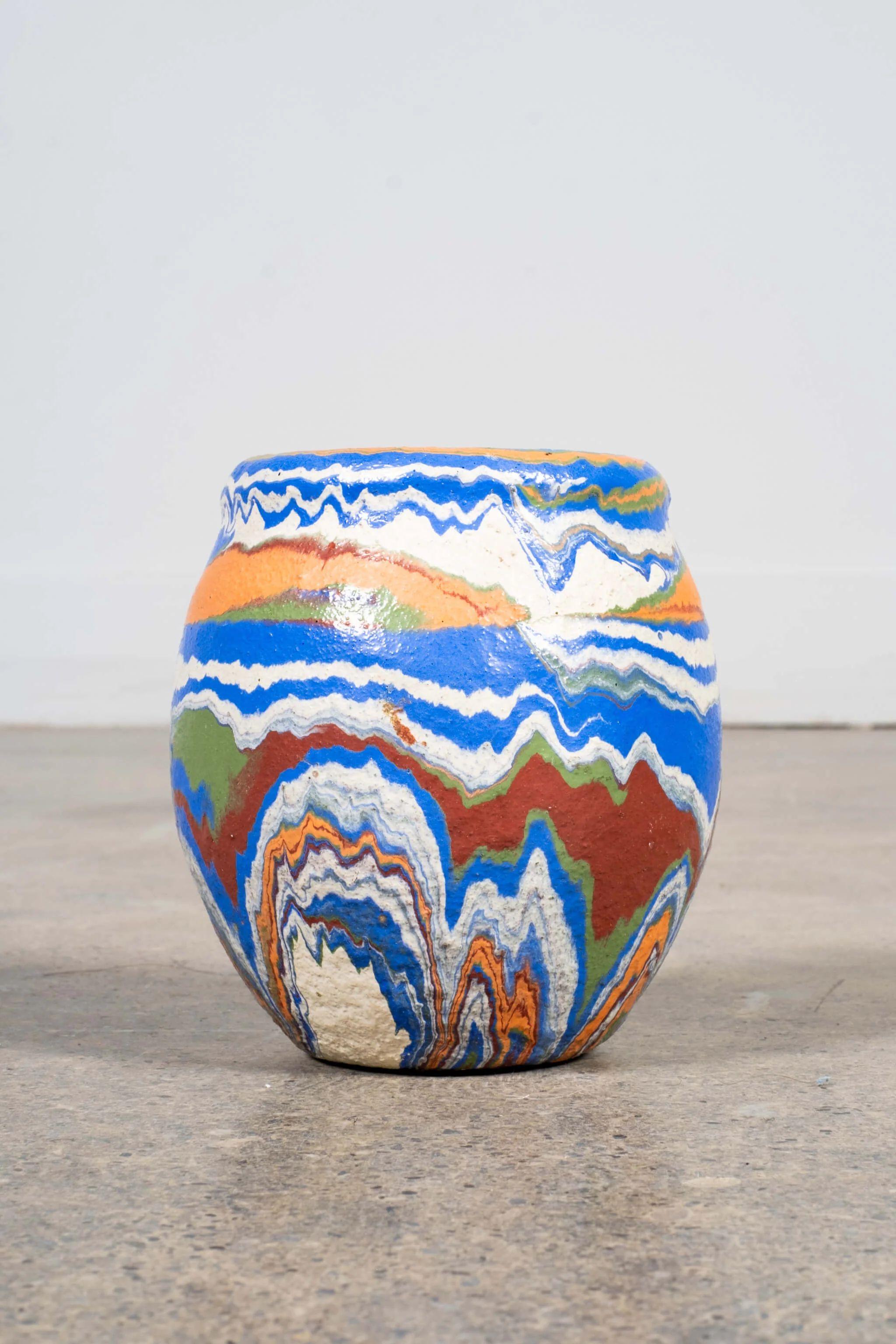 Blue + Mixed Swirl Vase

ABOUT OZARK ROADSIDE POTTERY
“Ozark pottery” refers to several mid-century American pottery makers that artificially coloured clay then turned pieces with marbleized swirls on the potter's wheel. Some makers include Ozark,