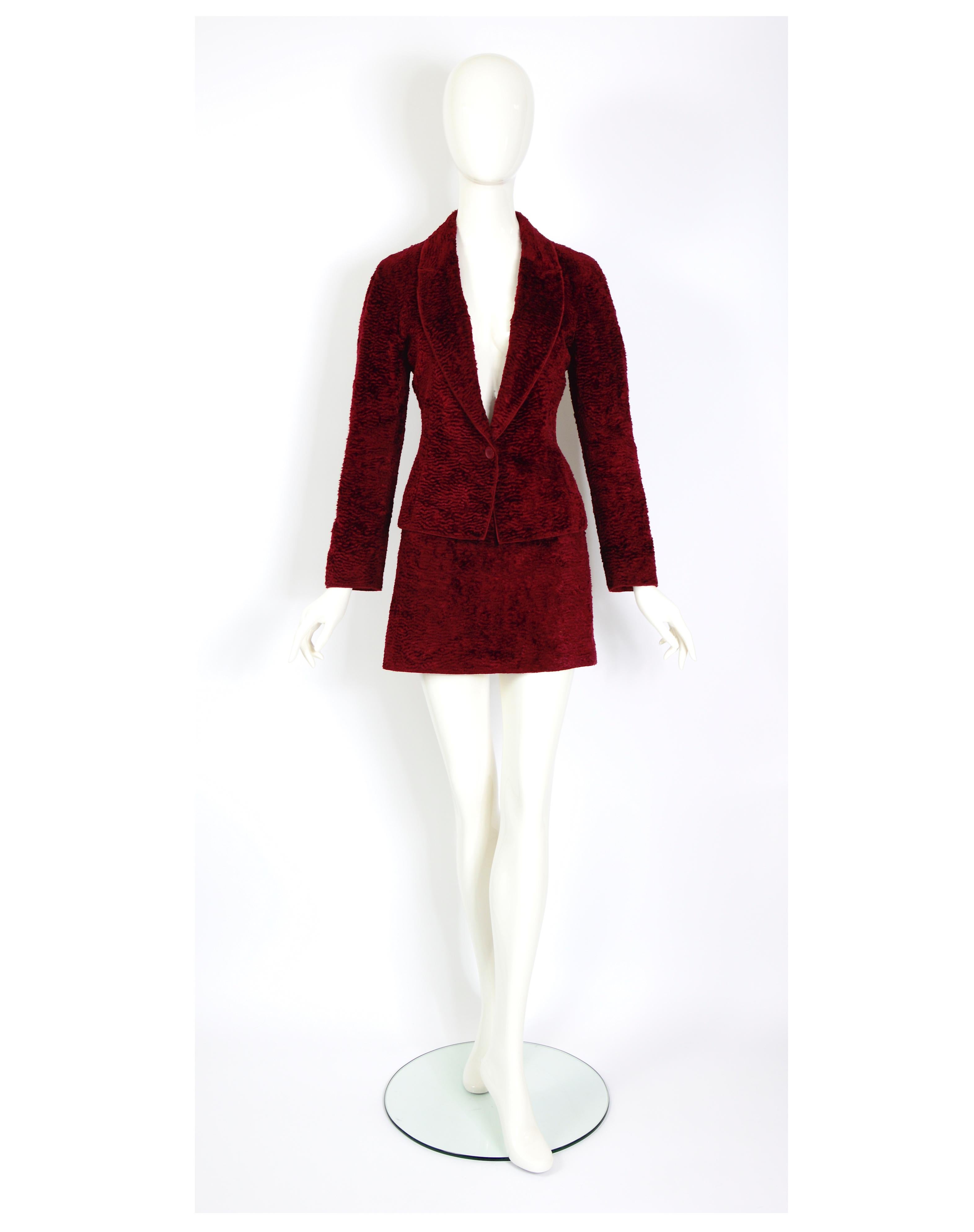 Verlaine Vintage presents an exquisite and timeless Ozbek by Rifat Ozbek's vintage 1990s tailored jacket and mini a-line skirt suit, made in a rich burgundy light cotton velvet, emulating faux Astrakhan fur.

Made in Italy.
The skirt and jacket are: