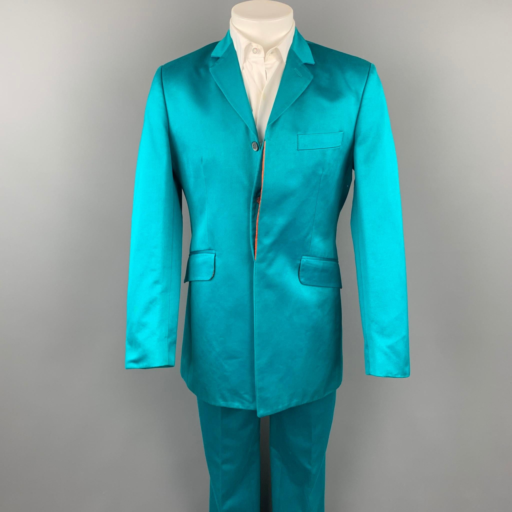 OZWALD BOATENG suit comes in a aqua cotton with a full orange liner and includes a single breasted, three hidden button sport coat with a notch lapel and matching flat front trousers. Moderate discoloration.

Good Pre-Owned Condition.
Marked: 38