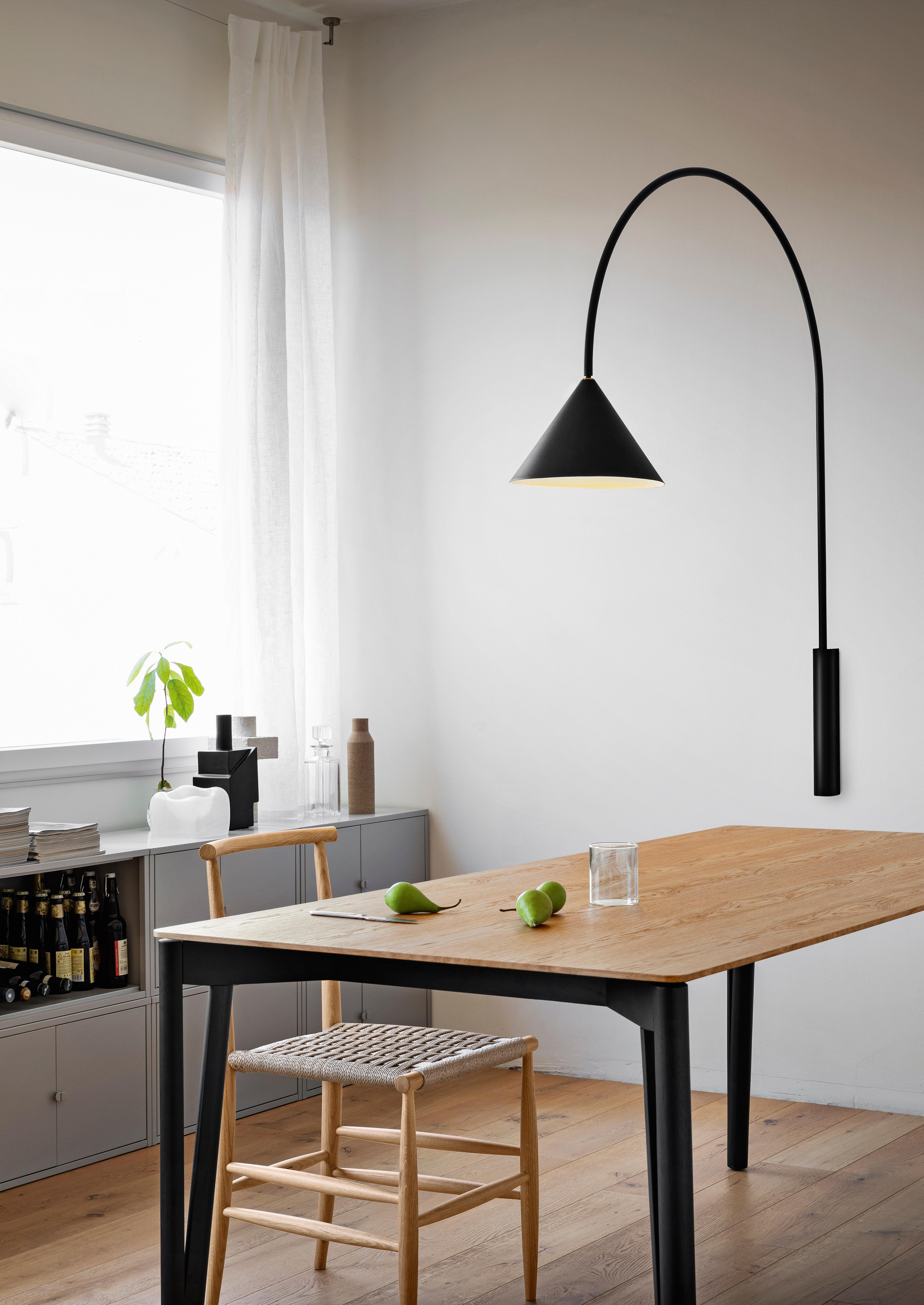 Ozz is also a winner at the dining table, where it becomes a wall lamp with a shorter arc that would look equally at home in the most elegant study.

Wall lamp in black metal with adjustable arch and shade.

Born in 1980 in Verona. Graduated in