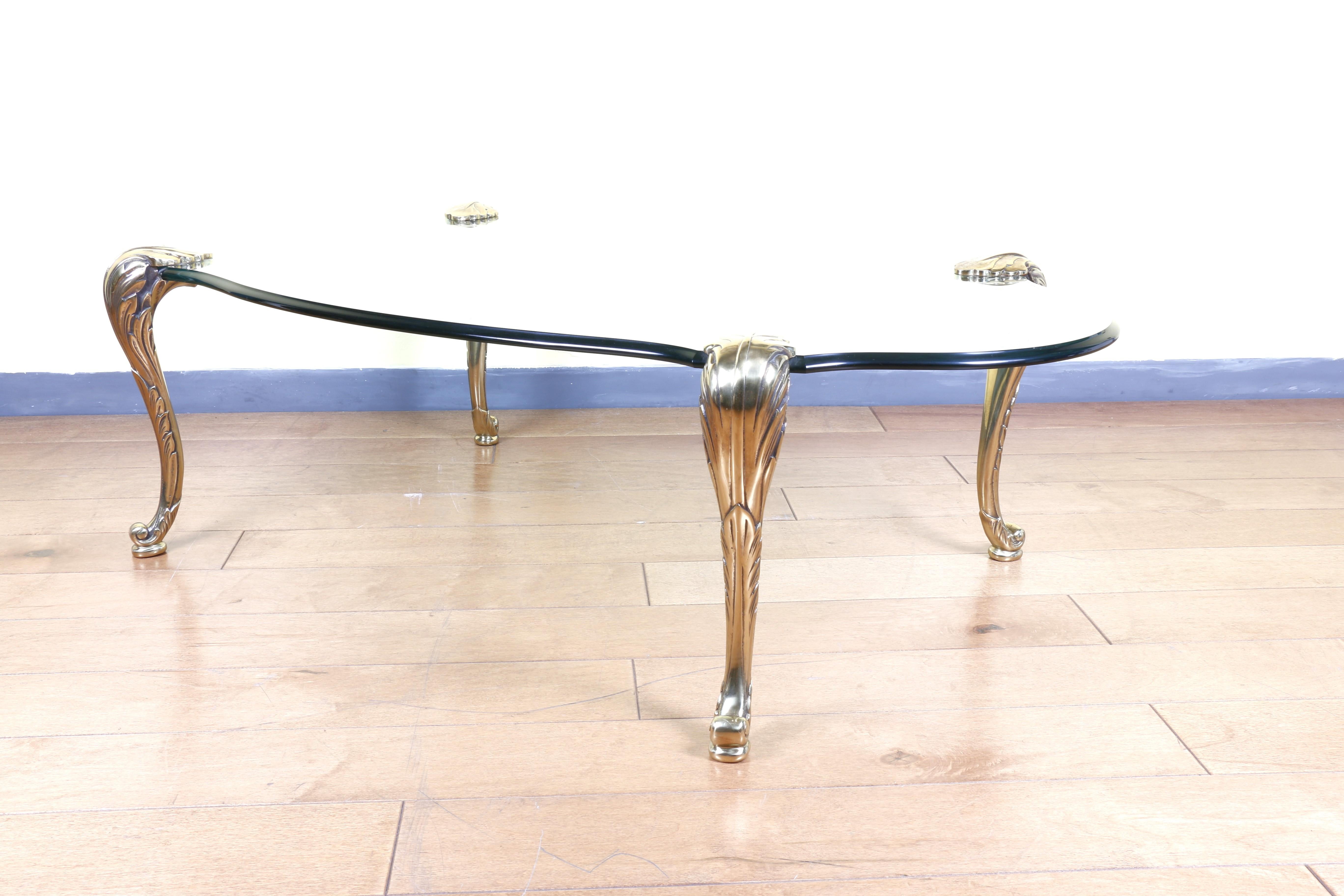 Great brass and glass coffee table by P. E. Guerin from the 1960s. No damage or chips of any kind. Very heavy and firm. It is made of brass and glass. Very good style. With beautiful details on the legs. It would look great in any home.