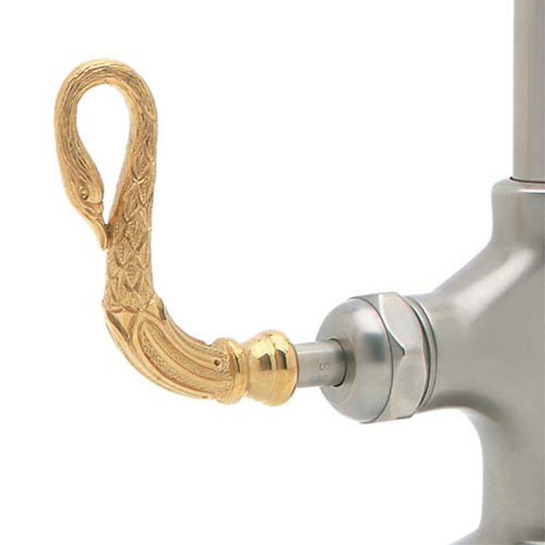 New P.E. Guerin swan faucet in pewter and gold. This beautiful faucet is brand new, and still in the box. Its spout features a gold swan in which the water runs out of the mouth. The main structure of the faucet is chrome and runs down to a single