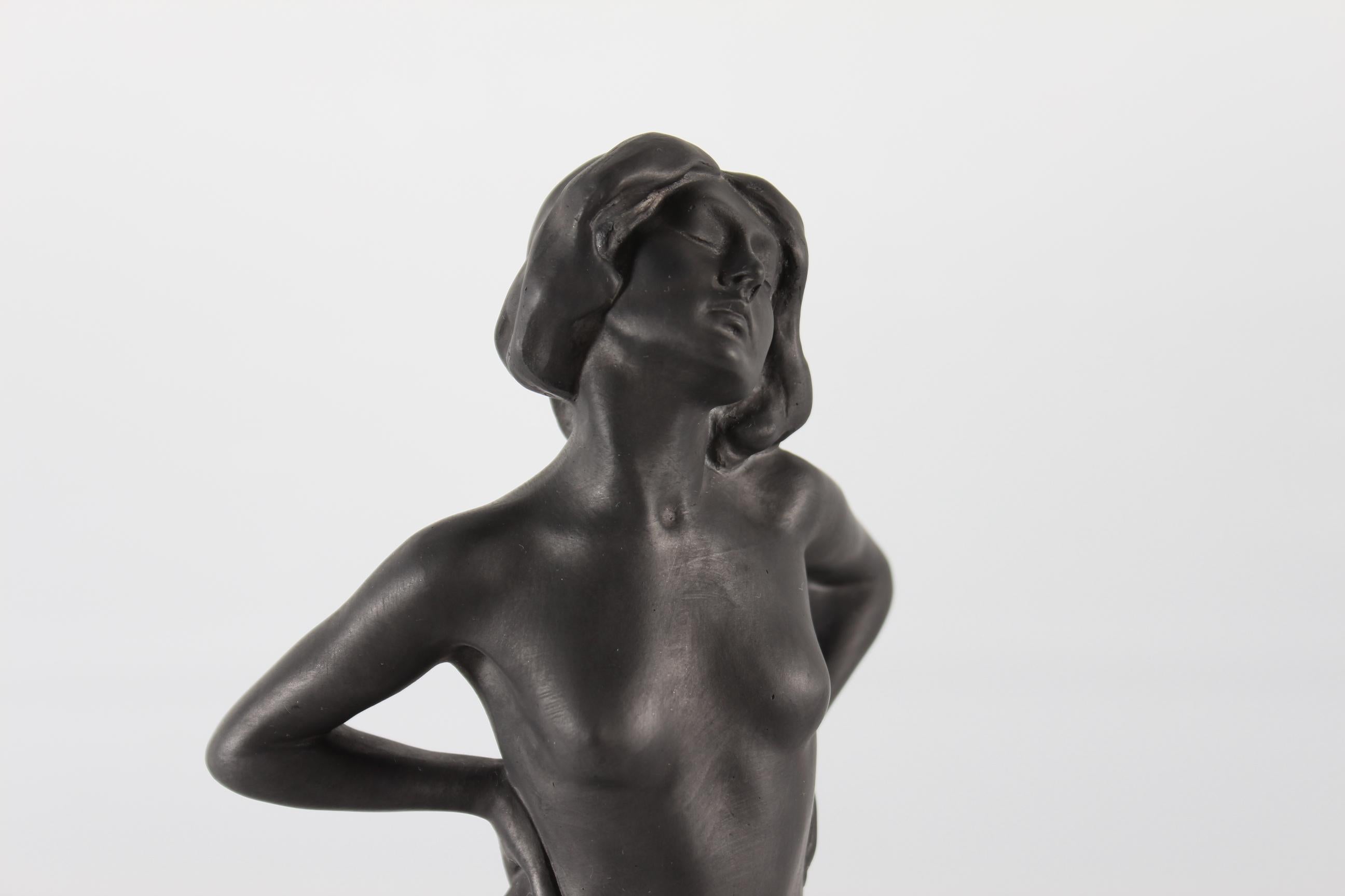 Very rare figurine of a young woman with a man at her feet designed by Danish sculptor Jens Jacob Bregnø (Bregnoe) Nielsen (1877-1946) and manufactured by P. Ipsens Enke circa 1900.

The figurine is made of black terracotta

Sign. J. J. Nielsen