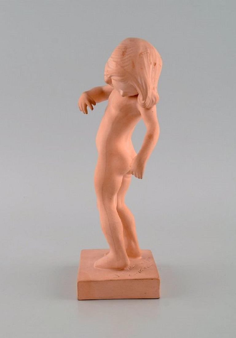 P. Ipsens Enke. Girl No. 888. Venus Kalipygos, Unglazed Pottery. 
Design Kai Nielsen. 1940s.
Measures: 20.5 x 10 cm.
In excellent condition.
Stamped.