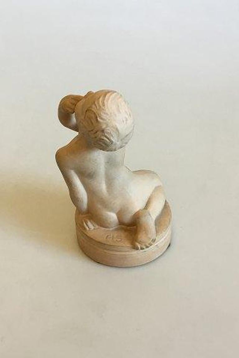 P. Ipsens enke terracotta figurine of sitting boy no 862. 

Measures 12.5 cm / 4 59/64 in.