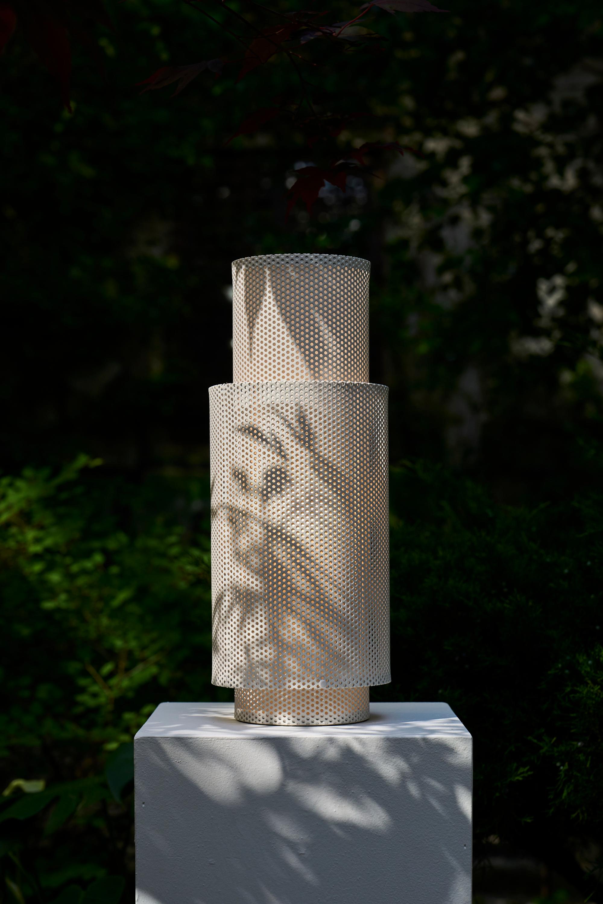 A composition of intersecting cylinders, the P-Lamp creates a dynamic moiré effect as light filters through its perforated volumes.

Rooted in a family tradition of metalsmithing, the P-Lamp was first prototyped in our sheet metal workshop in