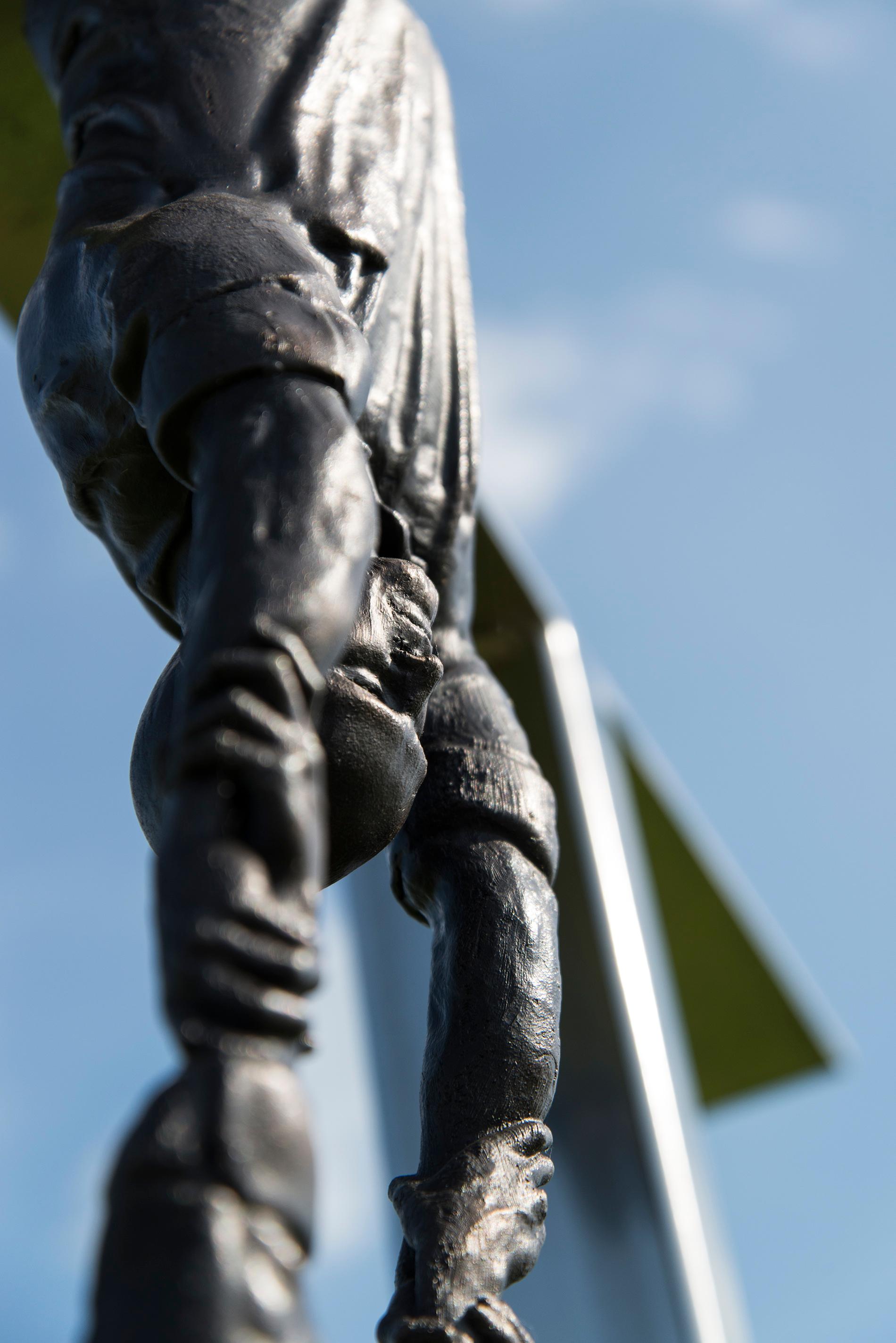 Hold Fast - tall, surrealist, male, figurative, bronze, steel, outdoor sculpture 1