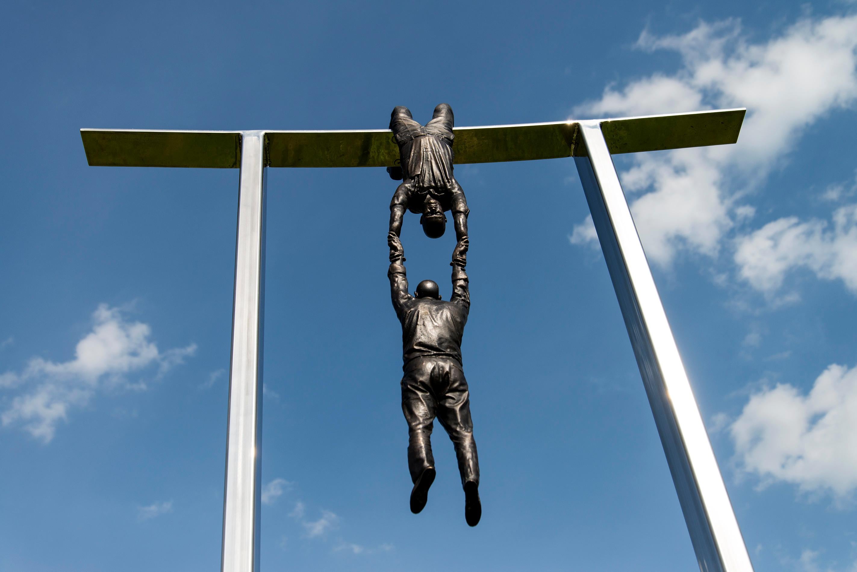 Hold Fast - tall, surrealist, male, figurative, bronze, steel, outdoor sculpture 2