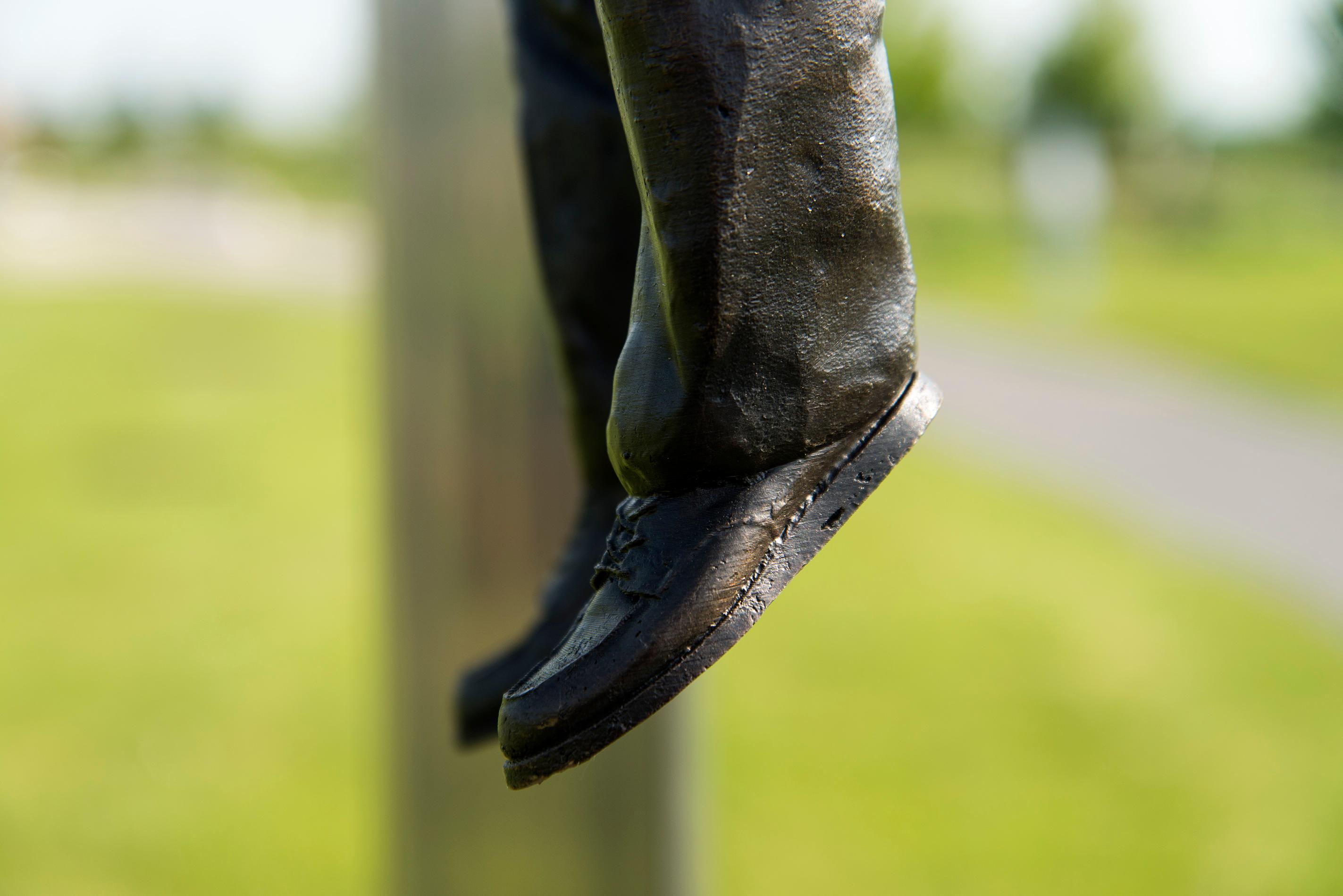 Hold Fast - tall, surrealist, male, figurative, bronze, steel, outdoor sculpture 3